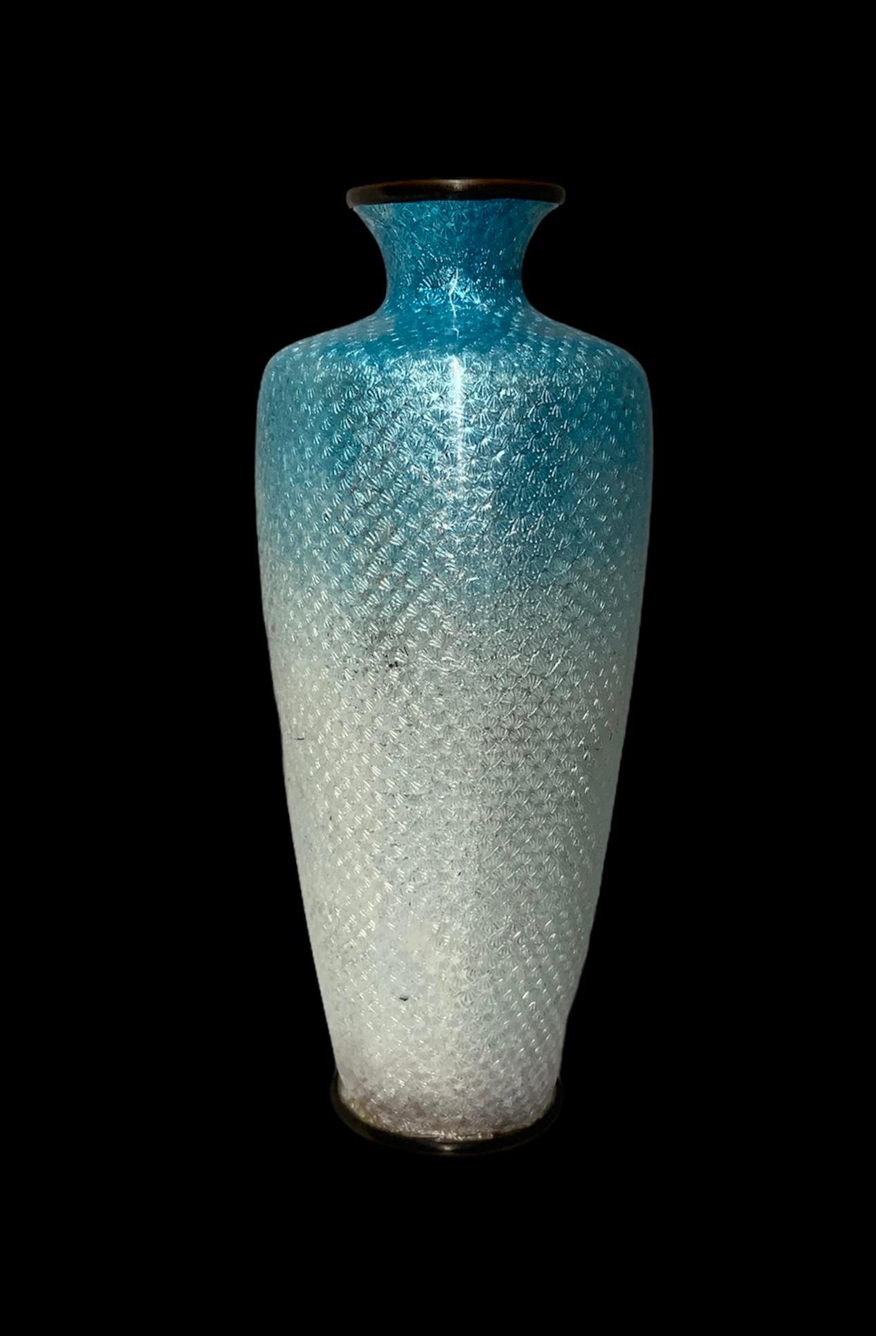 This is a Japanese Cloisonné foil metal urn shaped vase depicting a scene of a bird standing over a large flower branch.