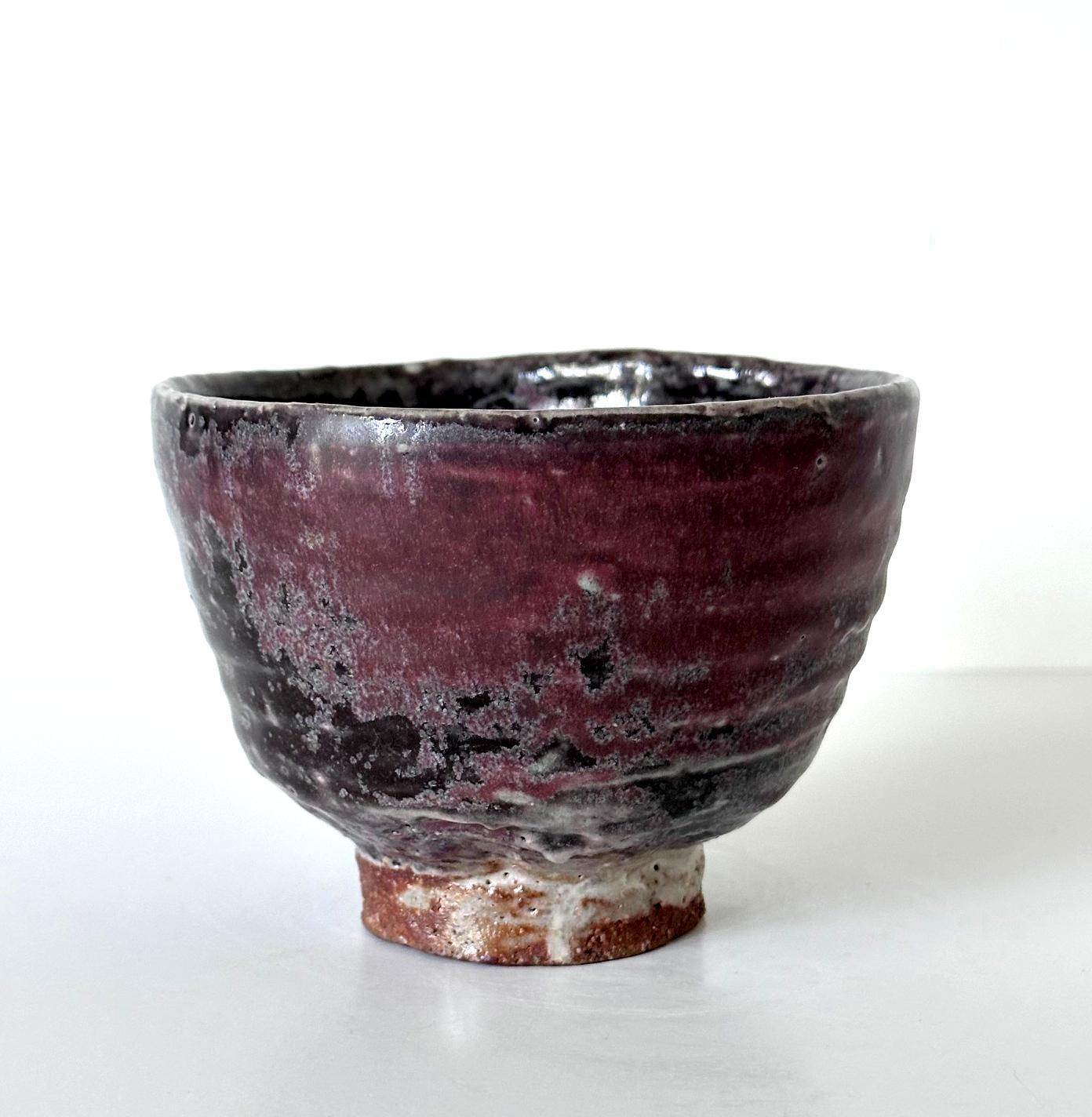 A Japanese ceramic Gohon tea bowl (Chawan) with a slightly irregular wall circa 18th century of Meiji Period. Supported by a high notched foot ring that was left unglazed, the chawan has a hand-pinched shape with a large dimple on one side. The
