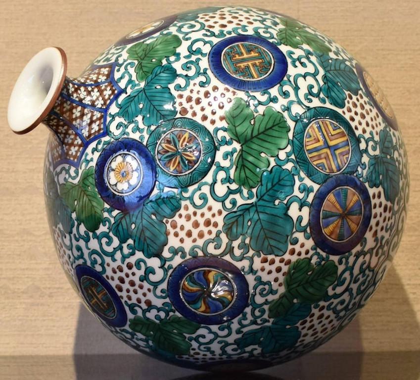 Extraordinary Japanese contemporary decorative porcelain vase, intricately hand painted in a stunning pattern in Kutani green, blue, brown and yellow on a beautifully shaped ovoid porcelain body in white, a signed masterpiece by highly acclaimed