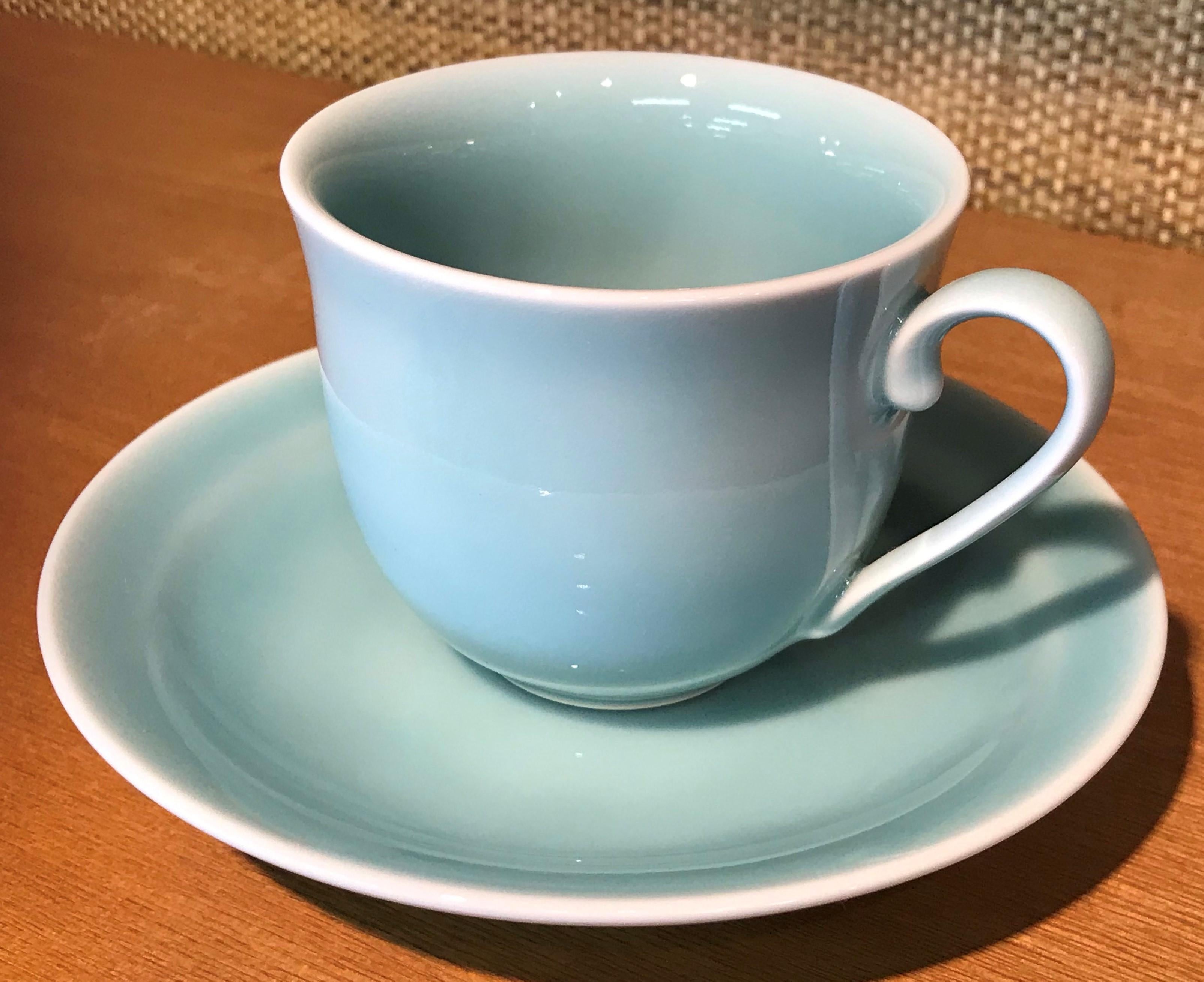 Exceptional Japanese contemporary porcelain cup and saucer, hand-glazed in a pleasant soft blue and green on a beautifully shaped body. This is a signed work by a highly acclaimed award-winning master porcelain artist from the Imari-Arita region of