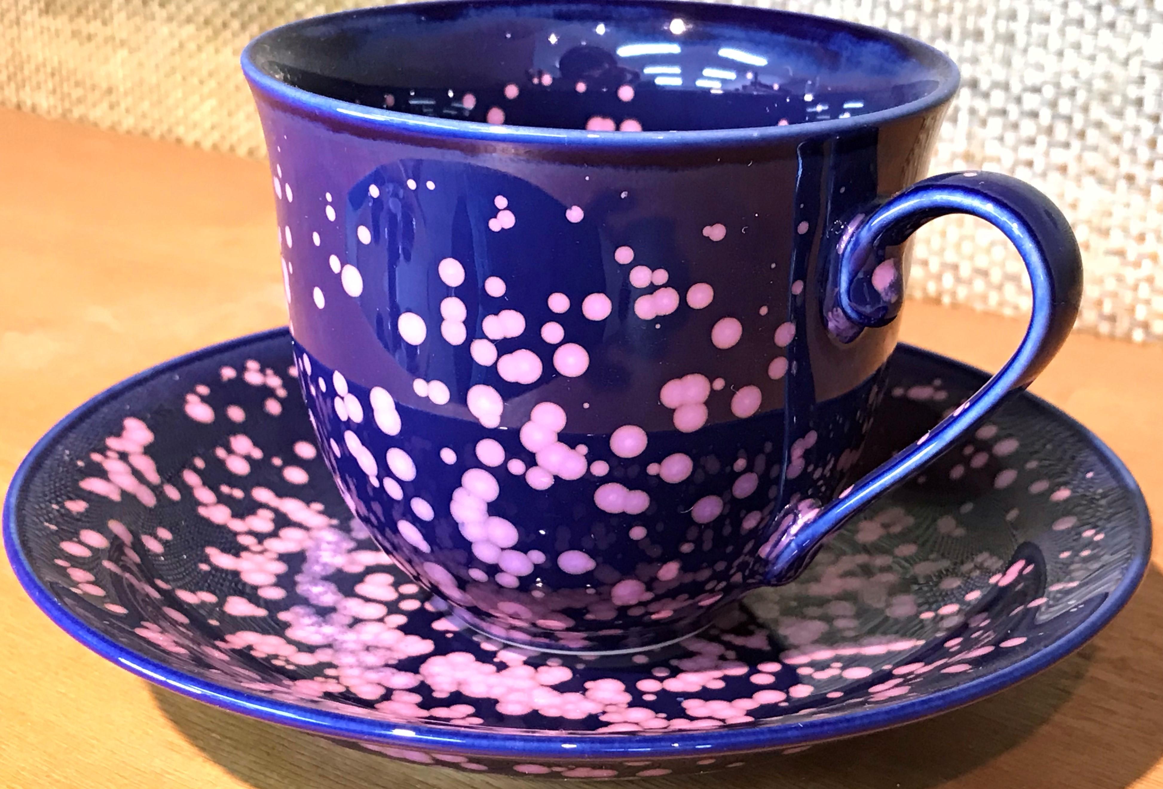 Exceptional Japanese contemporary porcelain cup and saucer, hand-glazed in a stunning vivid deep blue and pink cherry blossoms on a beautifully shaped body. This is a signed work by a highly acclaimed award-winning master porcelain artist from the