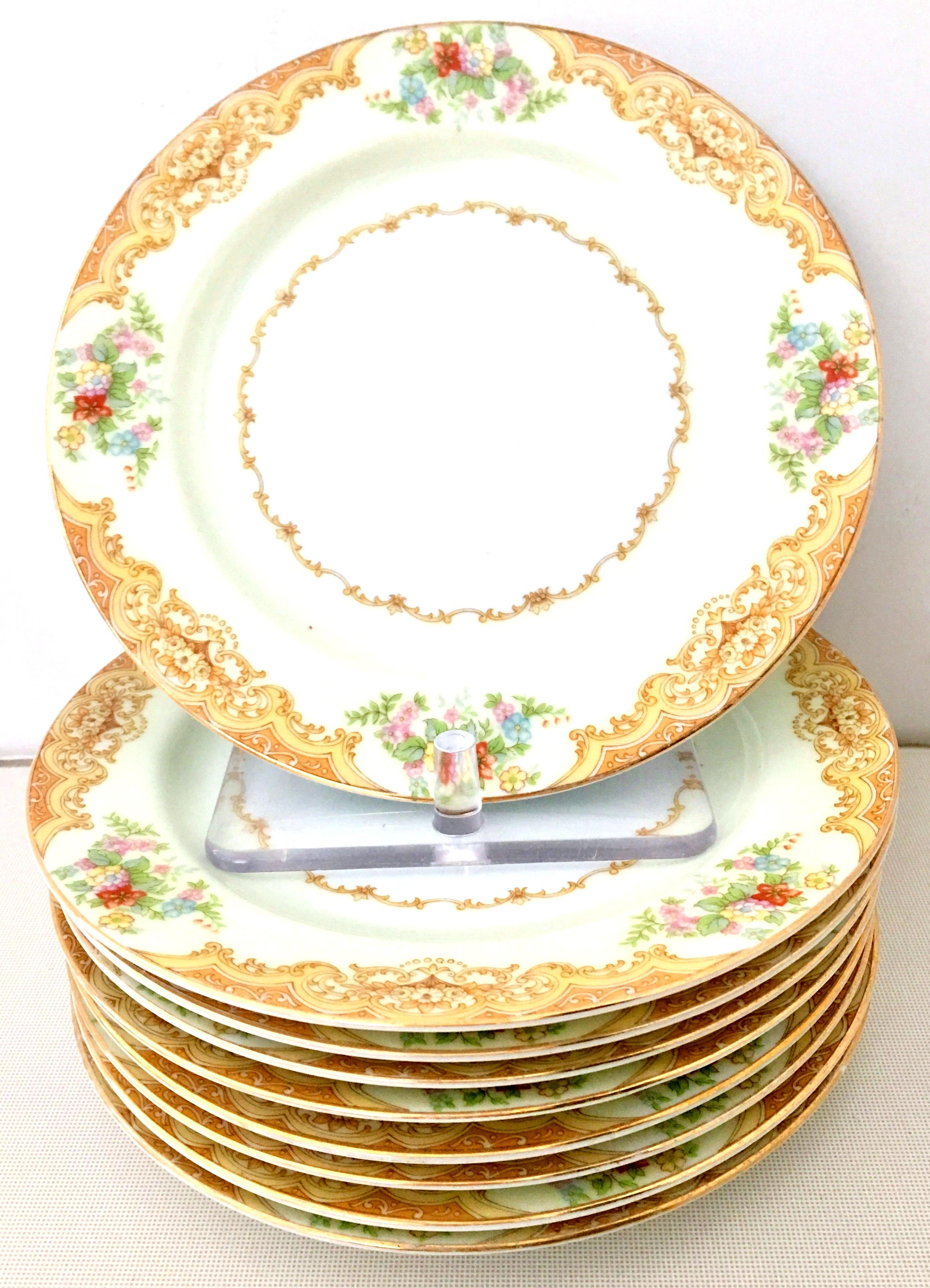 Art Nouveau hand painted Japanese porcelain set of nine salad/dessert plates by, Noritake-Morimura Brothers, 1930s. Pattern features a golden paisley and scroll rim pattern over a band of creamy yellow with a 22-karat gold edge detail. Each piece
