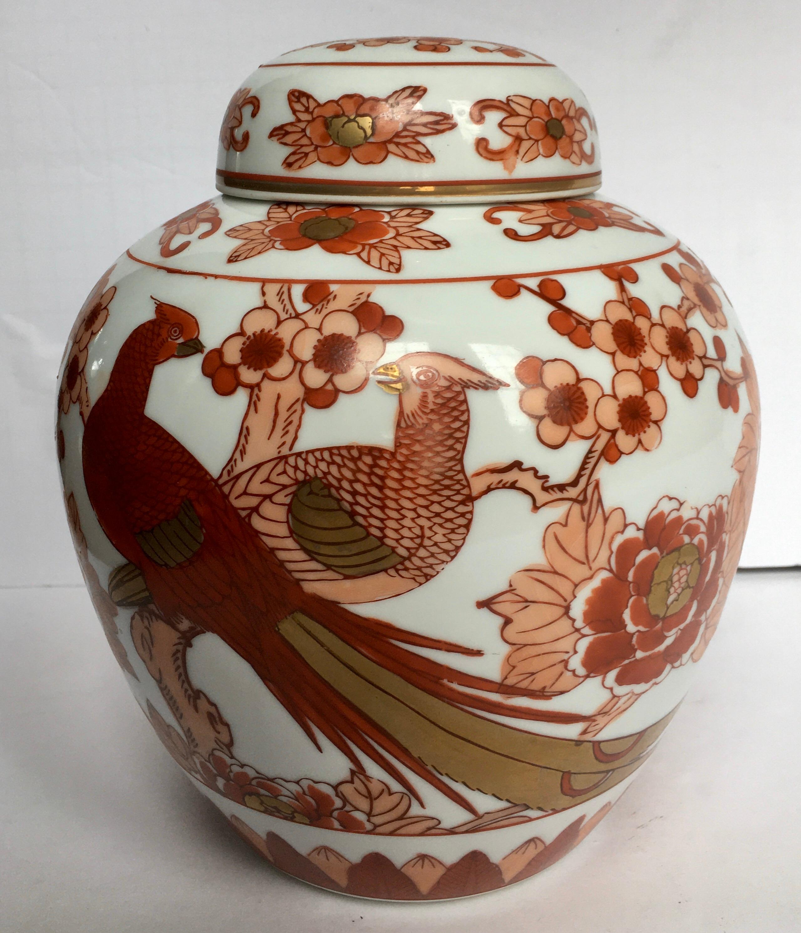 Hand painted Japanese Imari lidded ginger jar with floral cherry blossom and pheasant bird motifs. 