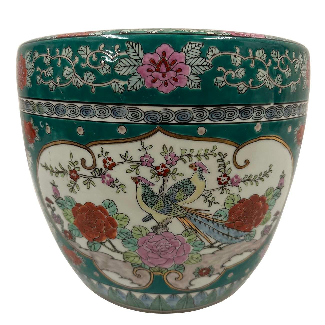 This Japanese Hand-Painted Imari Planter was hand made and hand painted with flowers and birds design and heavily enameled with colorful glaze on it.  A greenish glaze with rose colored flowers edges the upper rim and the lower base. Peony flower