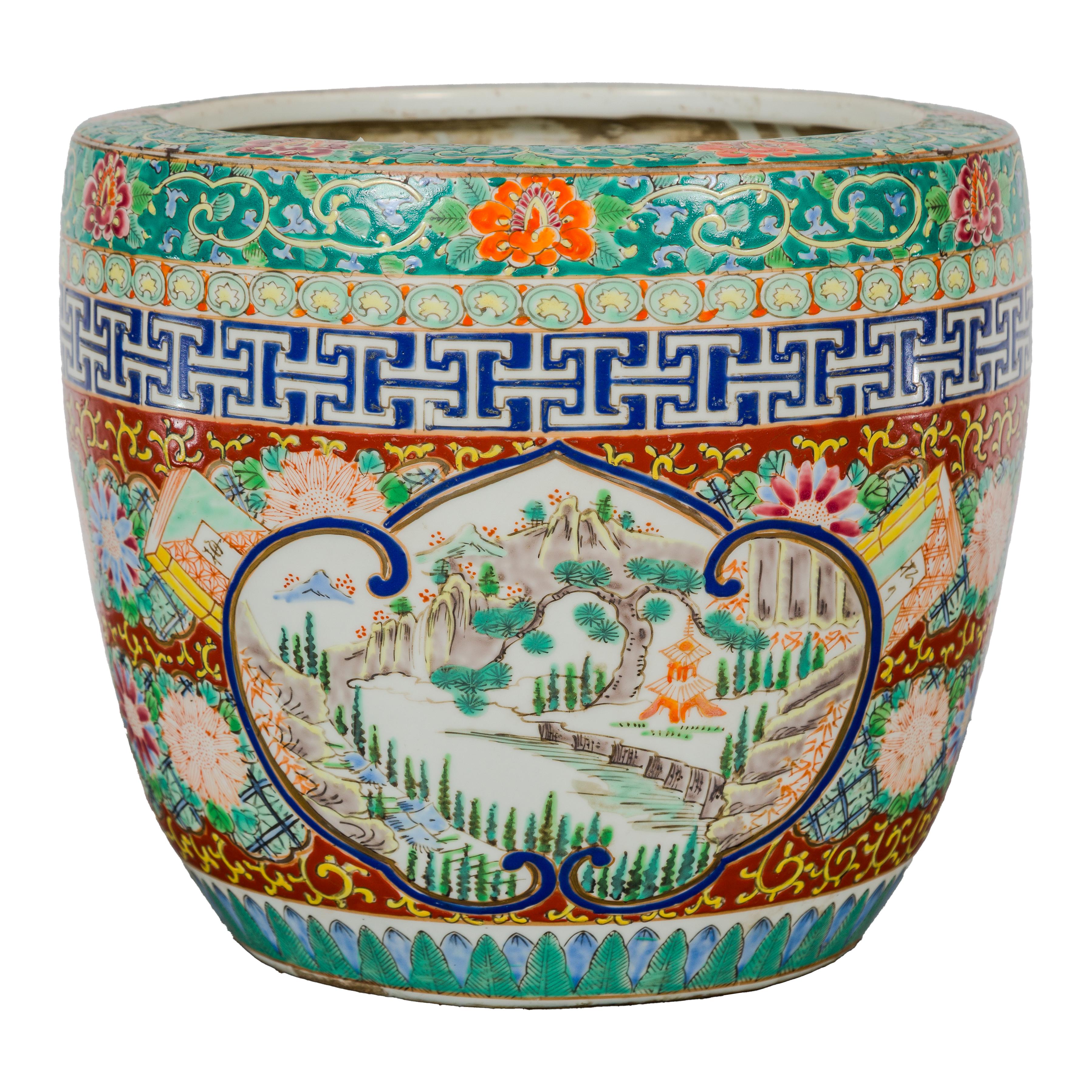 A hand-painted Japanese Imari porcelain planter from the early 20th century, with green, red and blue tones. This early 20th-century Japanese Imari porcelain planter is a celebration of traditional craftsmanship and aesthetic. Hand-painted with