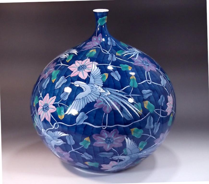 Phoenix has since ancient times been called the “king of birds” in China. 
Contemporary Japanese decorative porcelain vase, hand painted in red, green and blue on the finest porcelain in a stunning bottle shape body in a beautiful textured blue