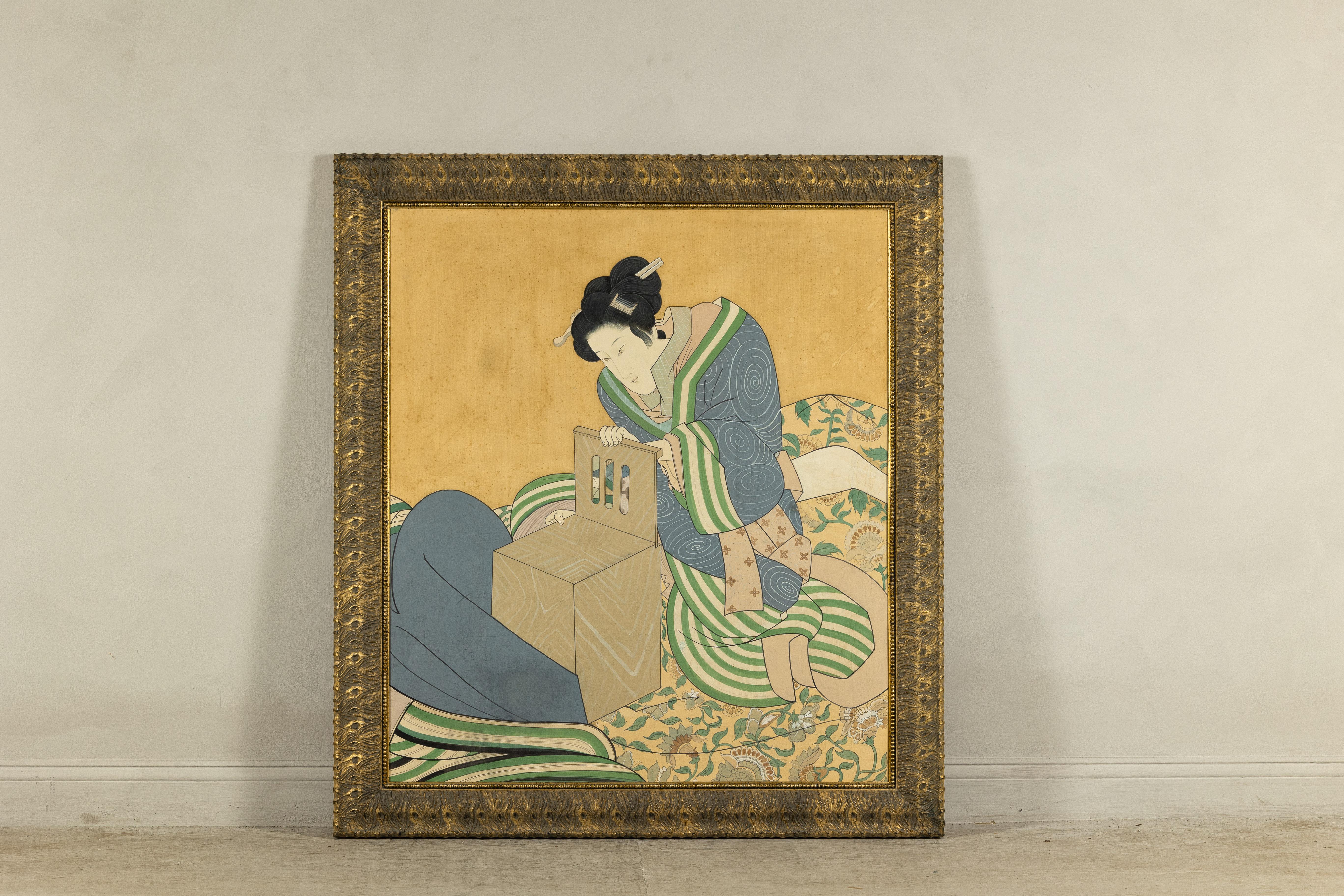 Japanese hand-painted silk artwork depicting a seated concubine in an intricate kimono, framed in a custom giltwood frame. This vintage piece captures a quiet moment of contemplation, rendered with delicate brushwork and a serene palette. The
