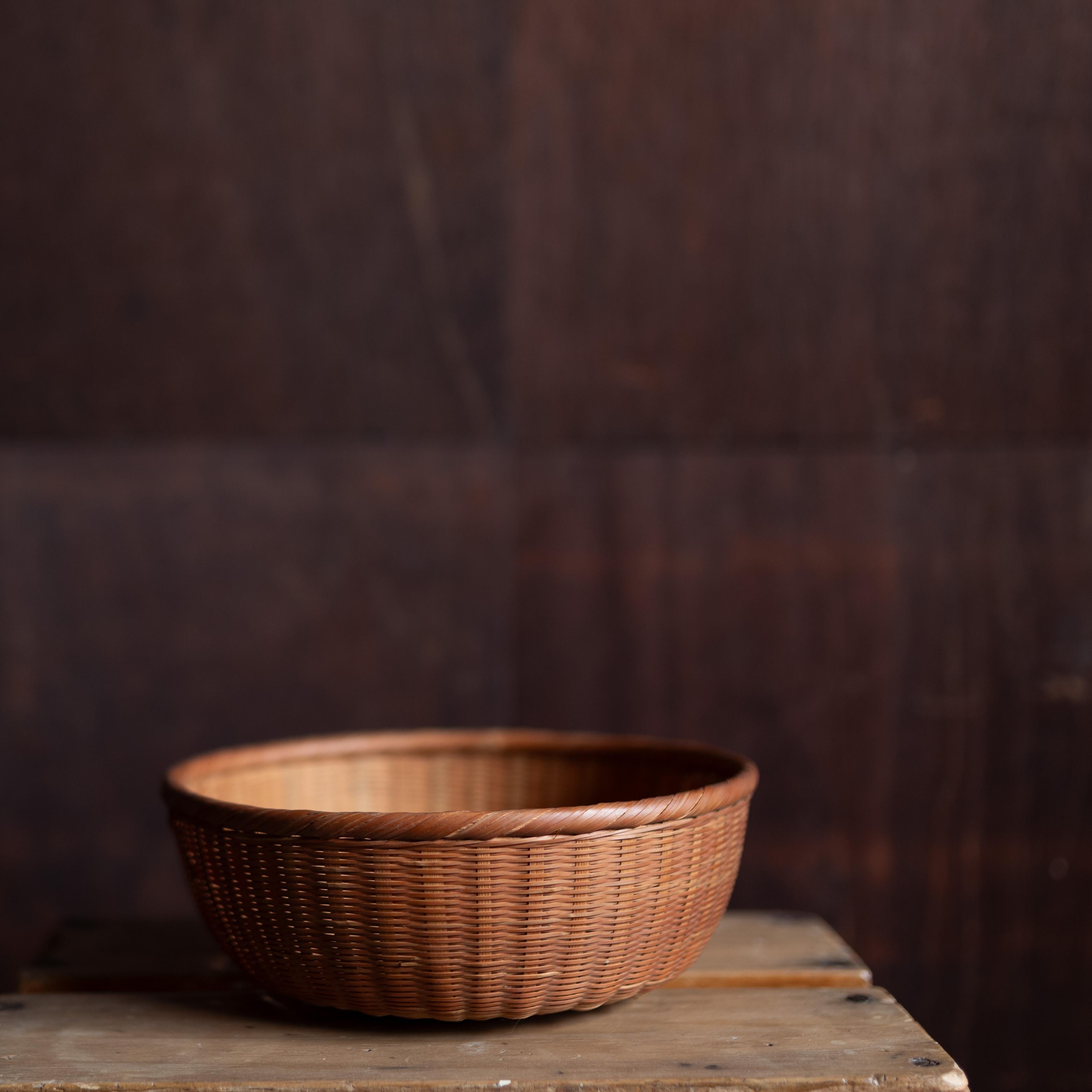 Beautifully handwoven basket from Japan, crafted with natural fibers in a traditional technique. Each piece demonstrates the refined balance of utility and simplicity characteristic of Japanese daily objects. The warm patina and subtle