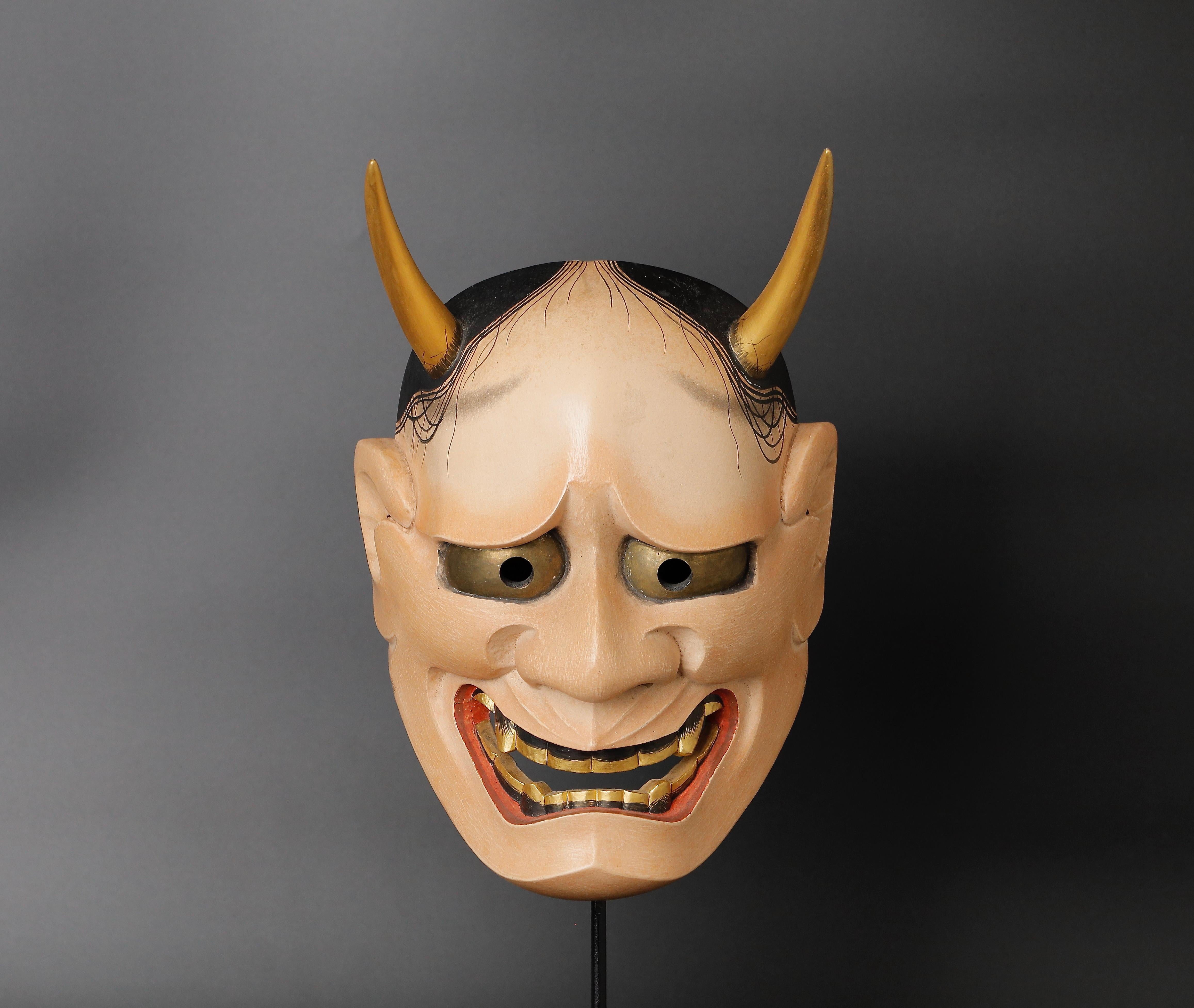 The Japanese Hannya Mask is a stunning and unique piece of art that is perfect for collectors of Japanese art and interior designers seeking to add a touch of Asian flair to their spaces. This particular mask was made in the mid-20th century by the