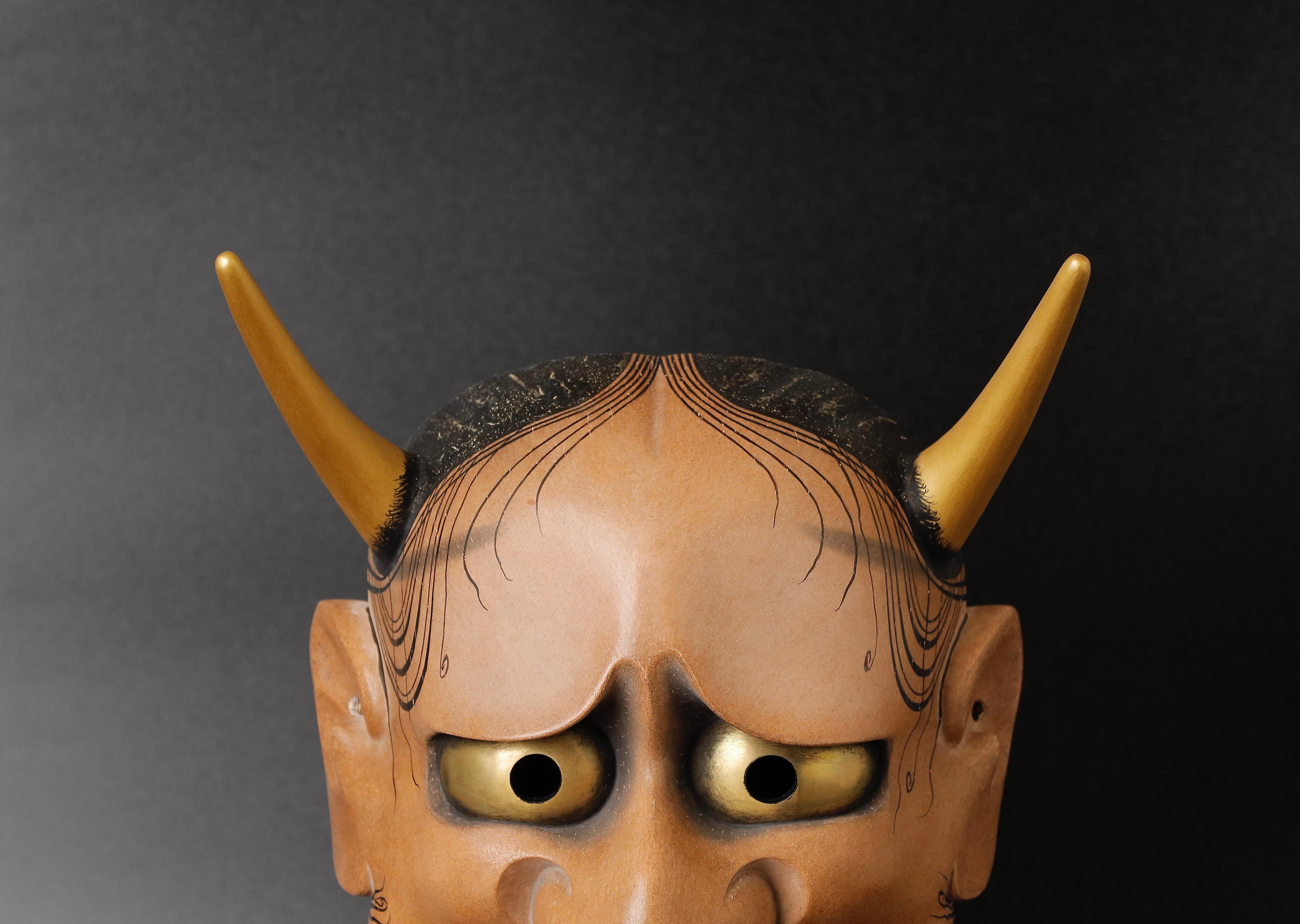 The Japanese Hannya Mask is a stunning and unique piece of art that is perfect for collectors of Japanese art and interior designers seeking to add a touch of Asian flair to their spaces. This particular mask was made in the mid-20th century by the