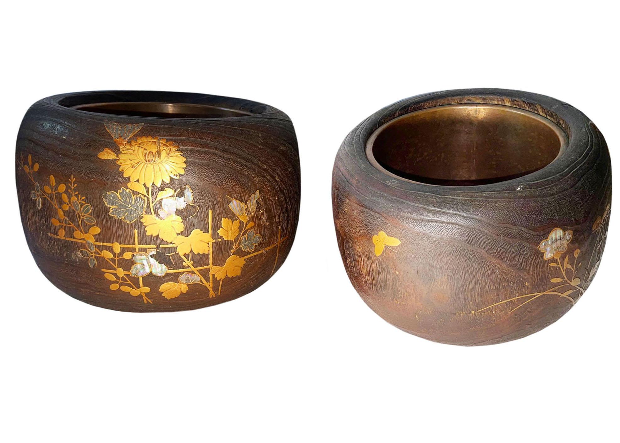 Pair of antique Japanese wooden hibachi braziers with lacquer and mackie, abalone and gilding with chrysanthemums. Some losses to decoration. Circa 1890 - 1900.  

