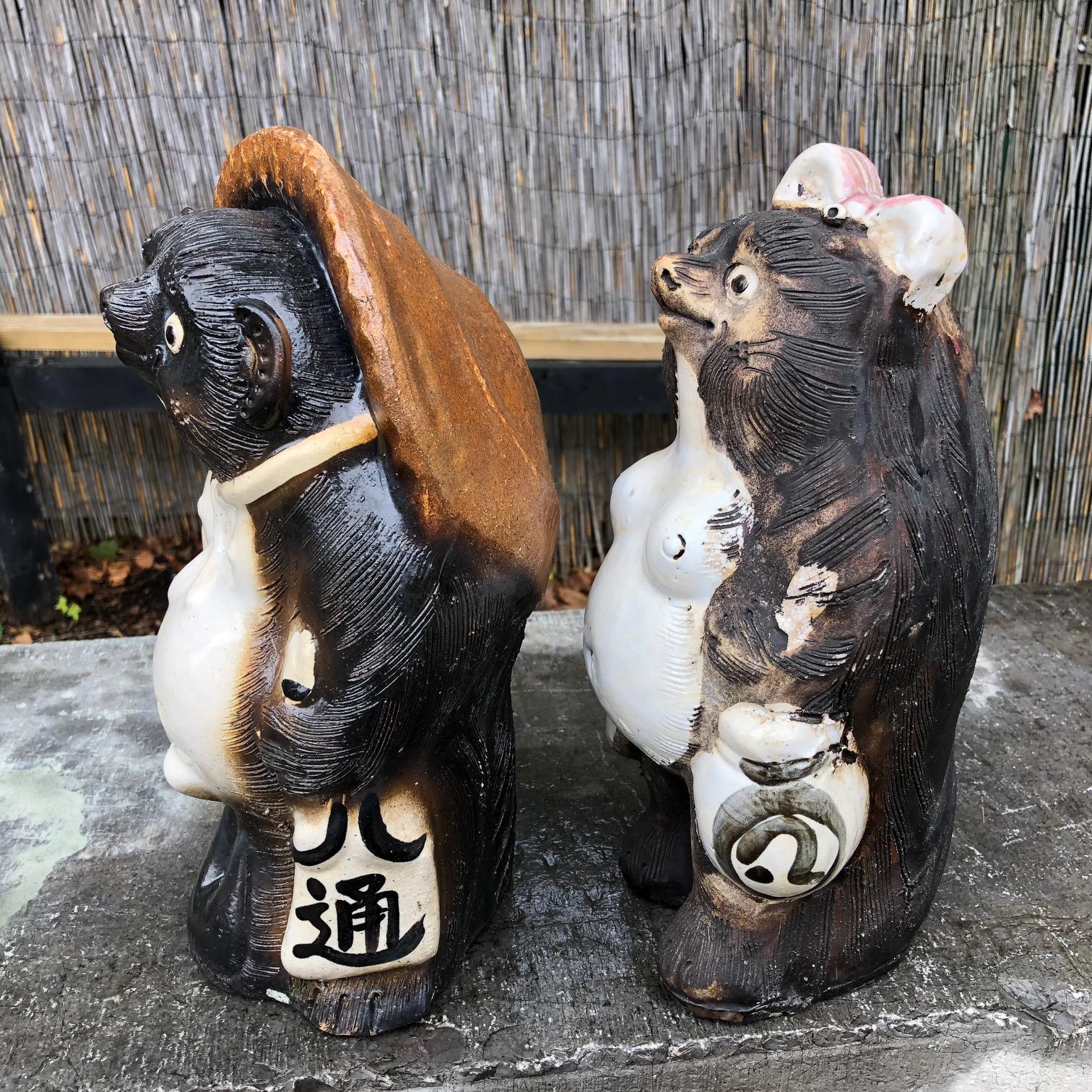 Matching Pair Charming Signed Sculptures Ready to take your Sake Order

An older pair of fun loving Him and Her handmade and hand glazed and big bellied Folk art Hero Tanukis- raccoon dog party animals from Japan.

Brandishing their sake order