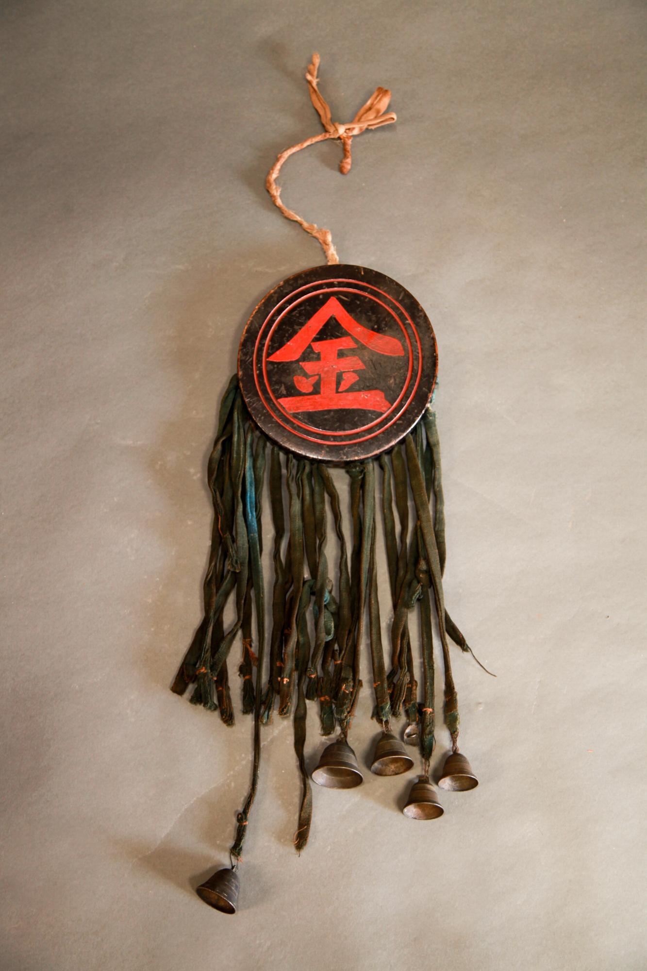 Japanese horse festival black lacquer medallion with tassels with bells, Edo period.

When horses participate in festivals they are adorned with horse trappings and other decorations. This is one of them, hangs around the neck and as they walk the