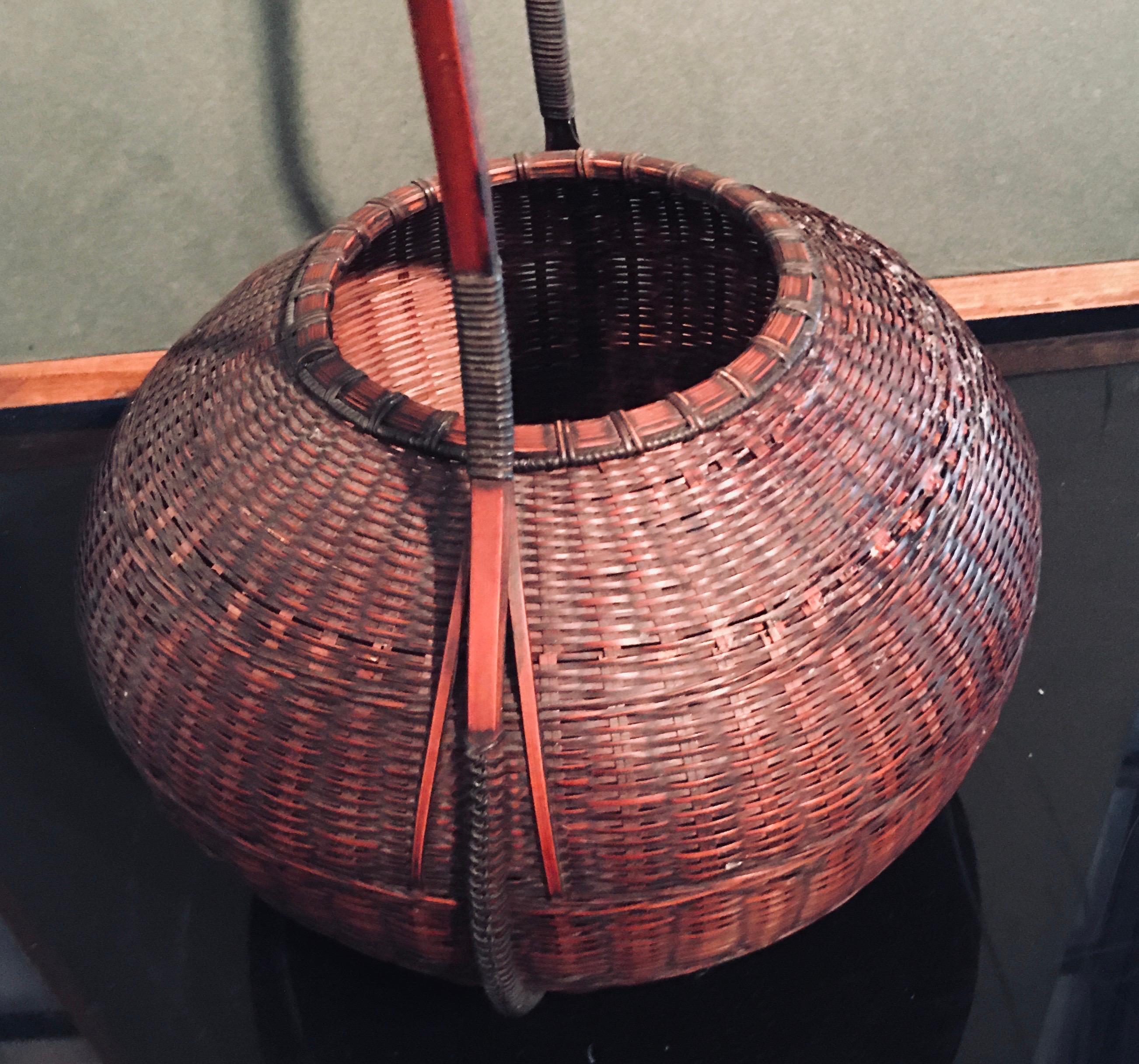Japanese masterpiece Ikebana basket, Intricately tightly woven fashioned from madake bamboo fine detail. An important collectors addition a masterwork in all aspects. Singed, minor stabilize areas. In fine antique condition. 19” H x 9“ W x 9