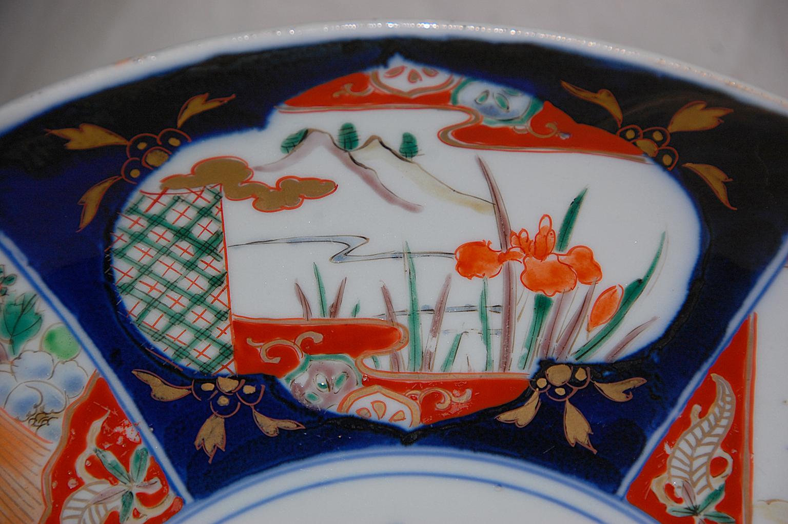 Japanisches Imari-Ladegerät aus dem 19. Jahrhundert, 15 1/2 Zoll, handgemalte Dekoration in Unterglasurblau und Überglasur-Emaille, hervorgehoben durch Blattgold. Diese Meiji-Platte ist recht symmetrisch und mit einem zentralen Blumen- und