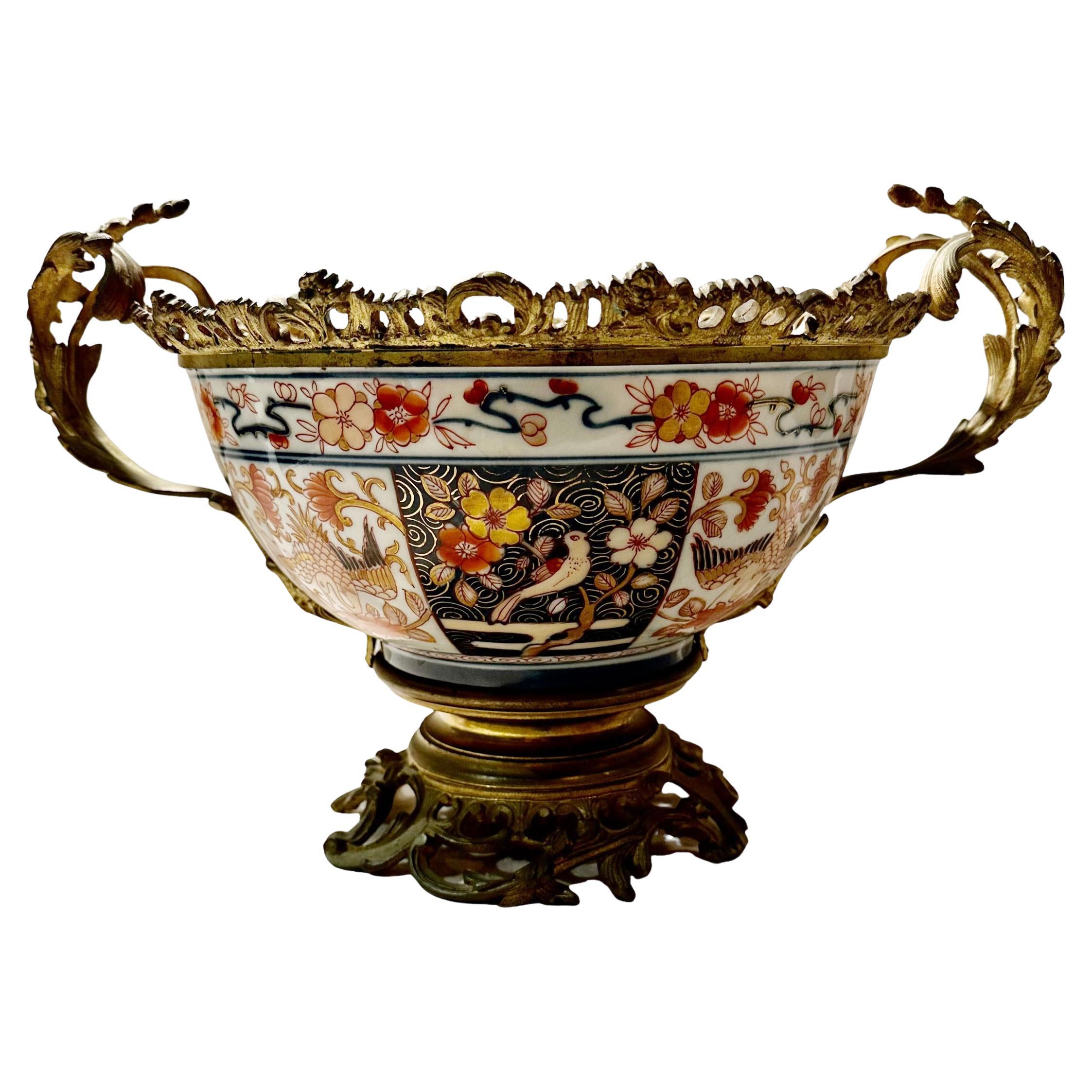 A 19th century Japanese Imari bowl with dore bronze mounts and a rococo base. Extremely fine painting on the porcelain.
