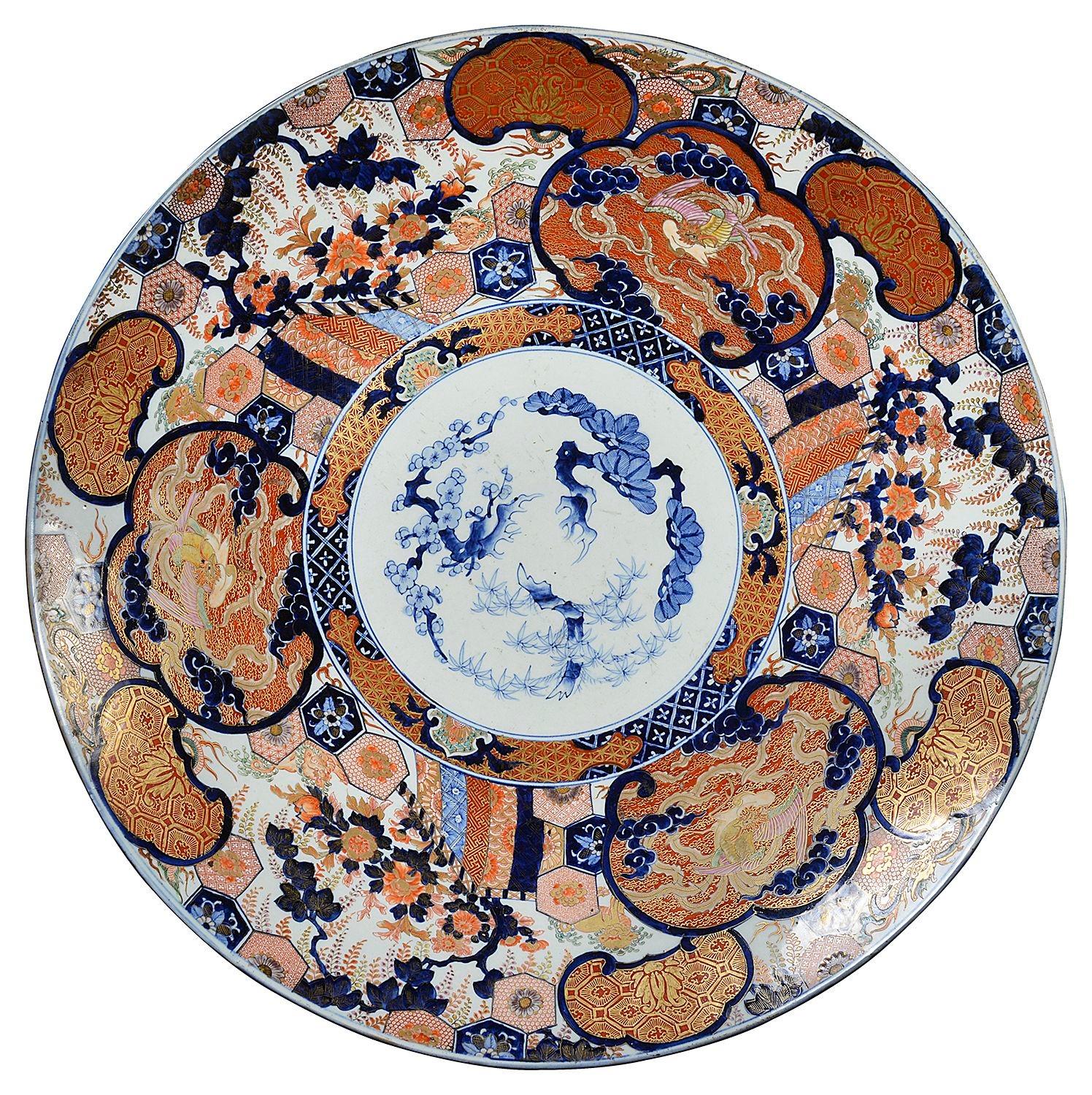 Large 19th Century Japanese Imari charger, having wonderful gilded and bold colouring, depicting hand painted classical motifs, blossom trees, exotic flowers and birds.
Including a brass plate stand.

Batch 78 62743 ANKZ