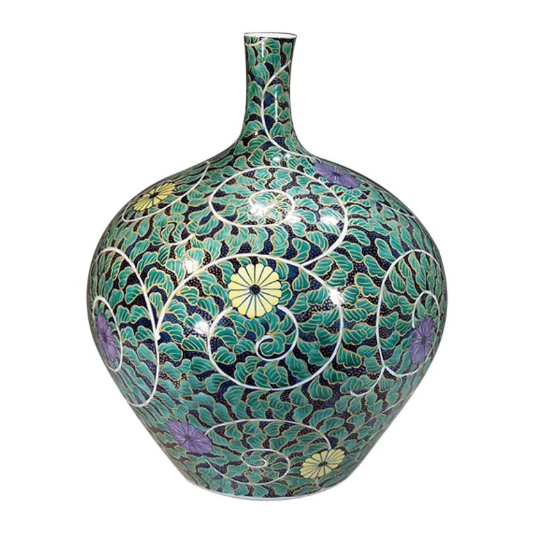 Exquisite Japanese contemporary decorative Porcelain vase, intricately hand-painted in green, black and purple on an attractive bottle shaped body, a signed work by highly acclaimed master porcelain artist of the Imari-Arita region of Japan. This