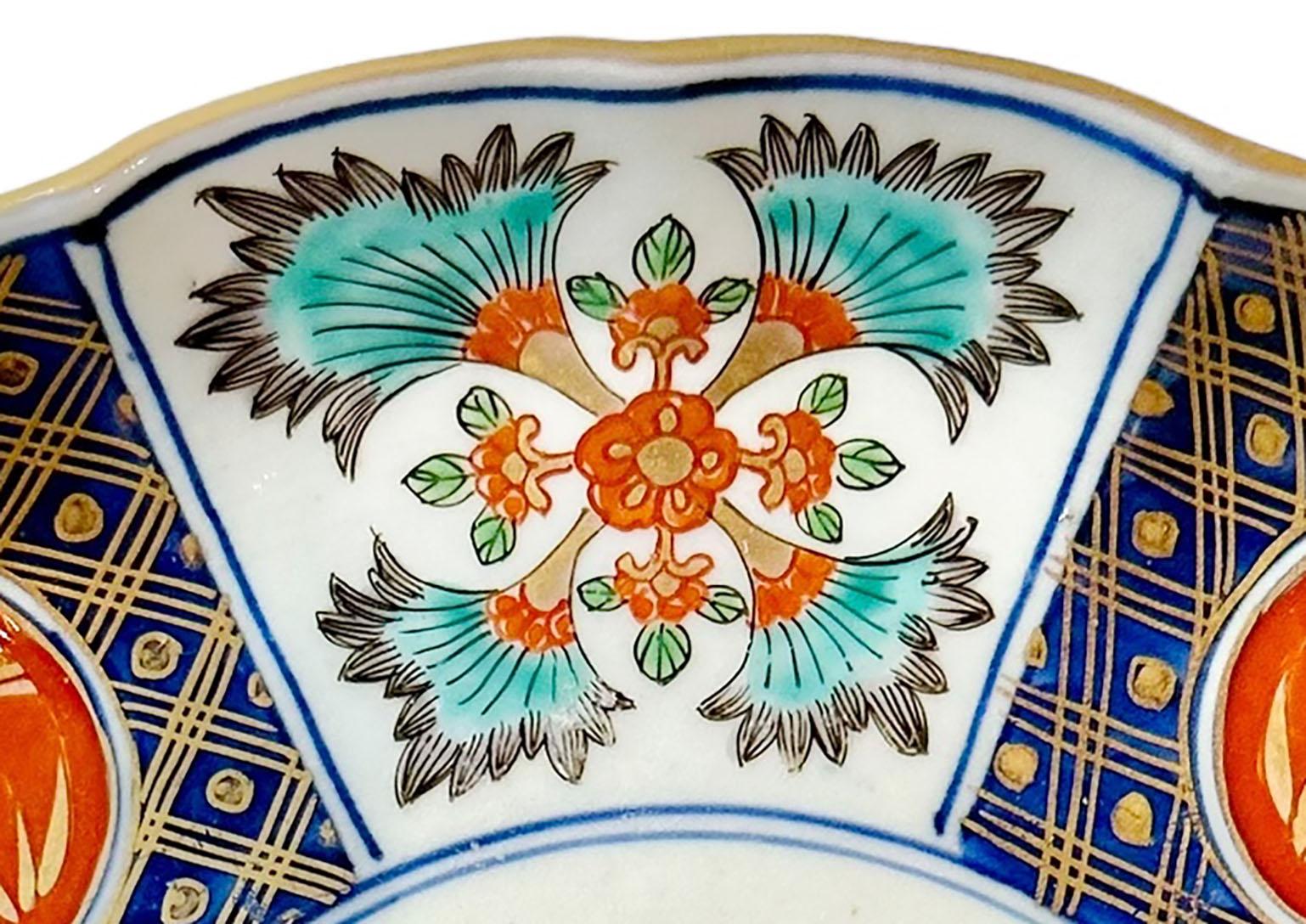 A late 19th century very colorful Japanese Imari plate with scalloped edges. Plate is signed.