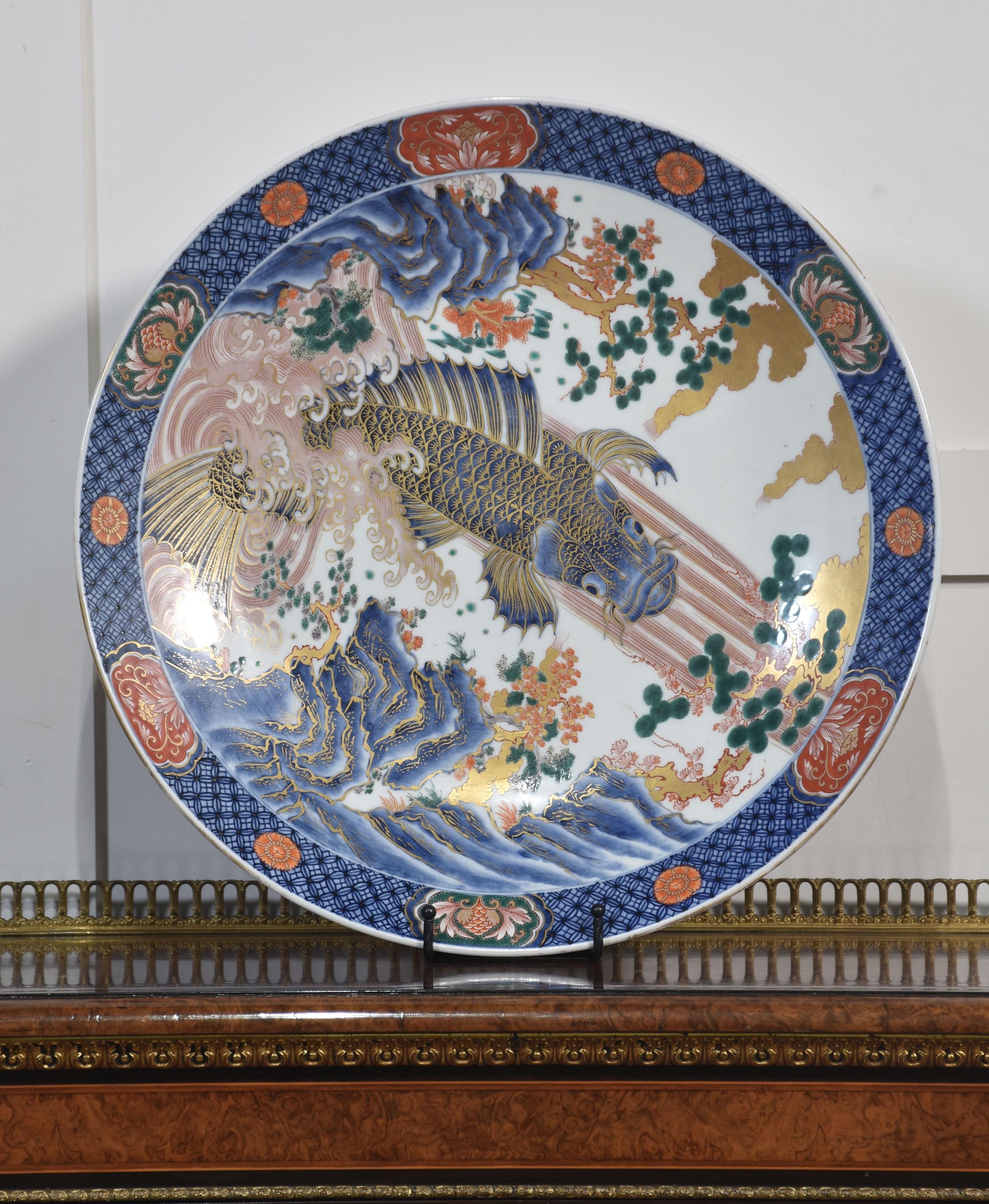 Japanese Imari plate, decorated with a leaping carp in traditional colours, heightened in gilt, six-character mark to the underside.
Dimensions
Height 2.5 Inches
Length 18.5 Inches
Width 18.5 Inches