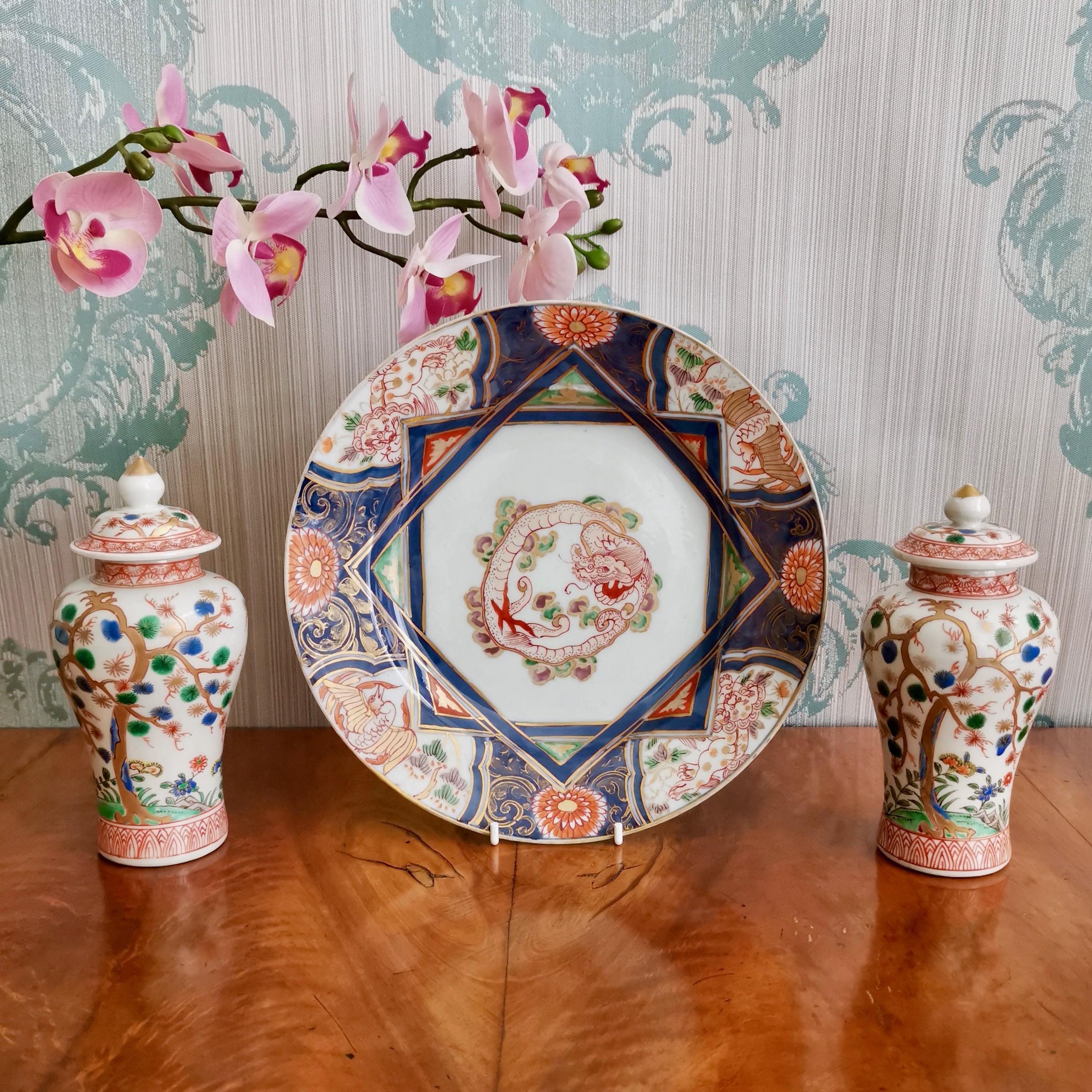 This is a beautiful plate with a dragon, two lions and two cranes. It was made in Japan in the Imari style some time between 1680 and 1700, during the Edo period. 

The plate is smoothly potted with bluish glaze, and has been finely painted with a