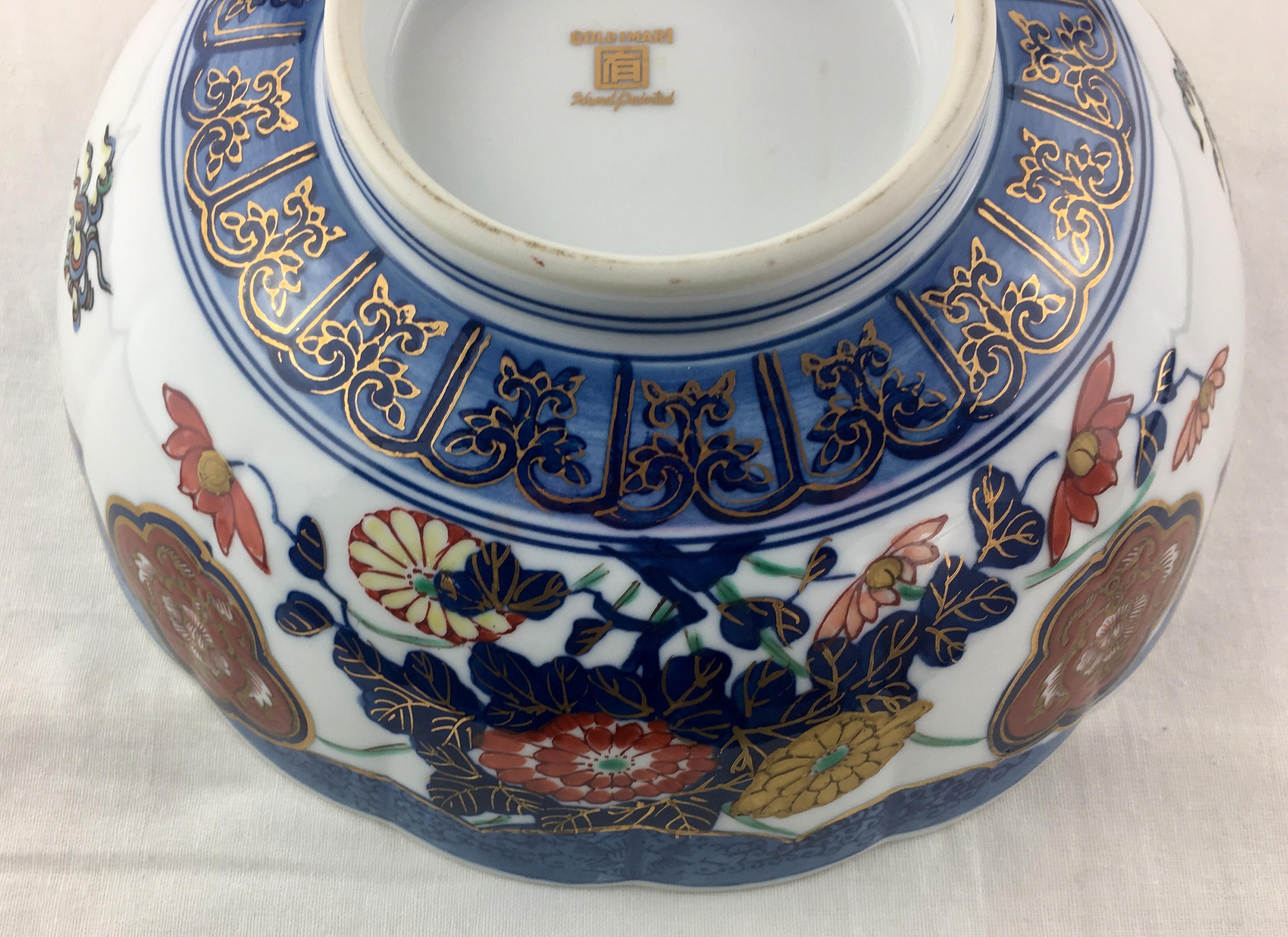 A Japanese Imari hand painted porcelain bowl possibly for presenting cooked rice at a celebration. It appears to be styled after a sushi oke, a wooden tub used in the preparation of sushi rice. 

This beautiful bowl is thickly painted and quite