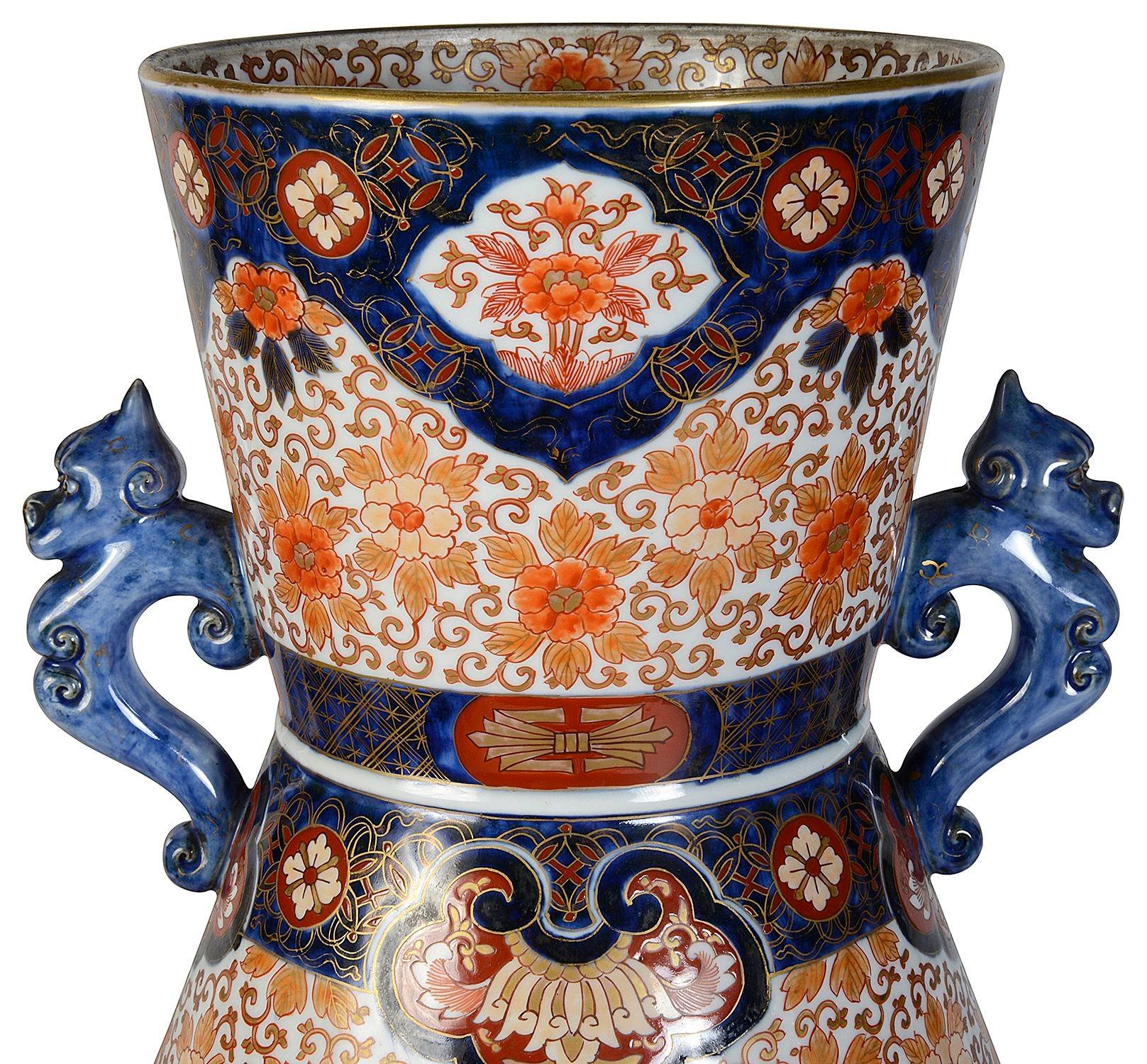 A very good quality late 19th century Japanese Imari porcelain vase, having wonderful bold classical Imari colours of blue, orange and gilt.
The ground with classical motif decoration, inset hand painted panels depicting blossom trees. Handles to