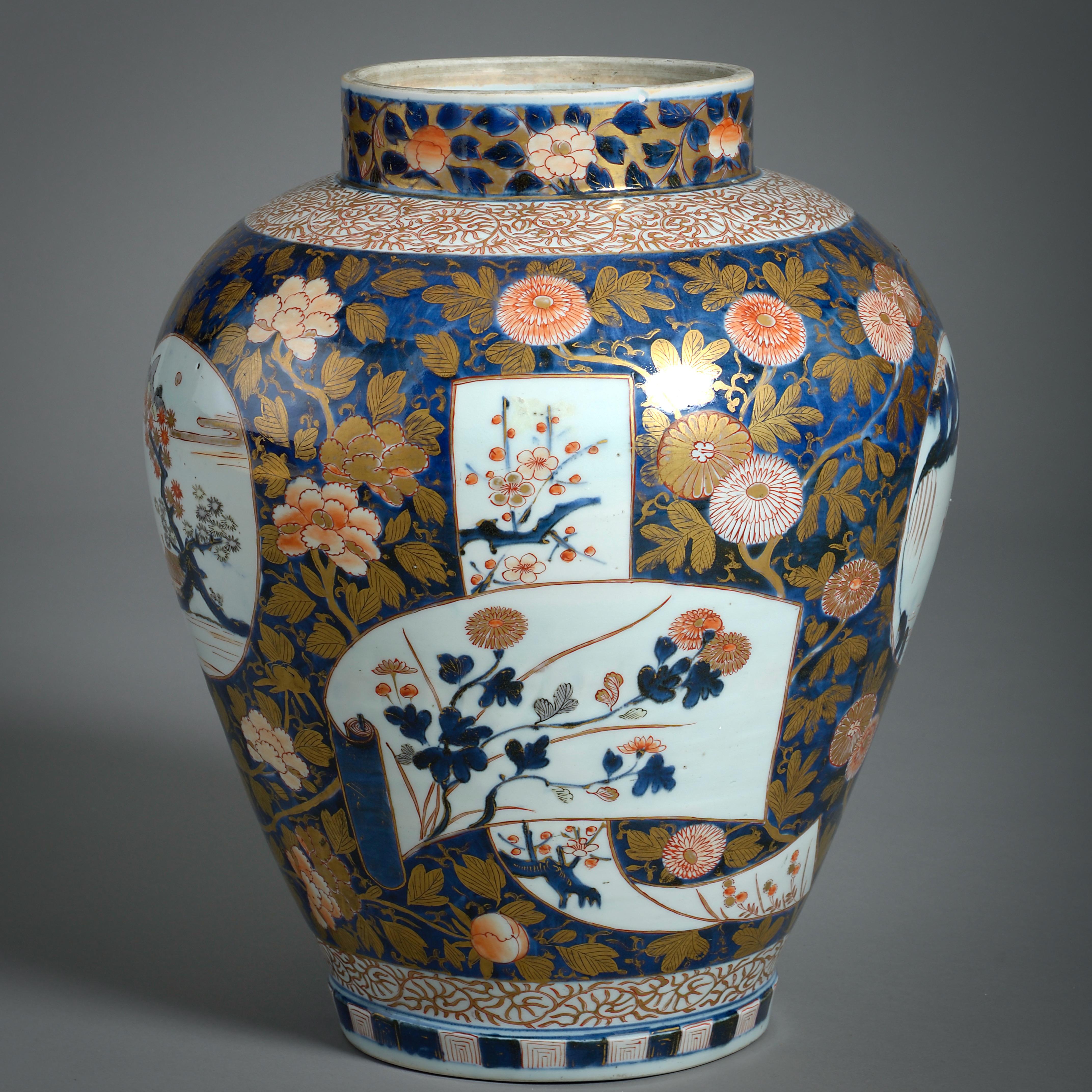 A fine Japanese Imari vase decorated with flowering branches framing paper scrolls and windows with views onto landscapes, circa 1700.