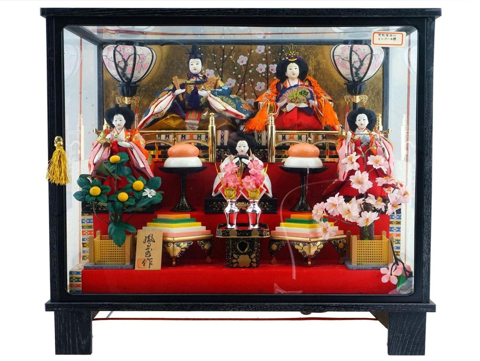 Charming diorama, circa 1990s, representing the coronation of Emperor Akihito, born 1933, the 125th Emperor of Japan who ruled from 1989 until his abdication in 2019.  With hand-painted ceramic bodies dressed in traditional jacquard fabric clothing