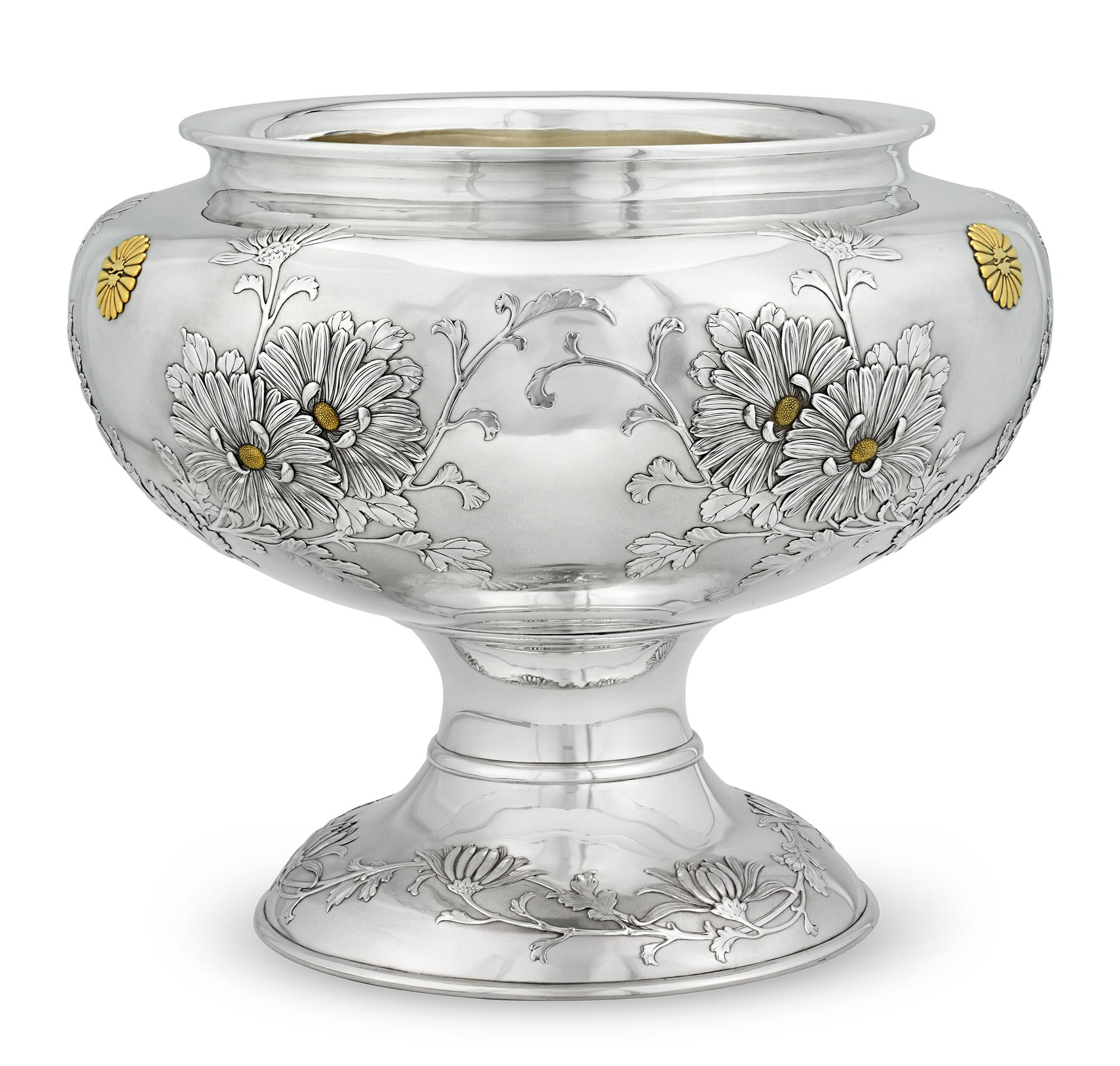 This monumental solid silver flower bowl was crafted for the household of Emperor Meiji. This rare treasure is emblazoned with the Imperial heraldry of gilded chrysanthemums. Handmade by the revered Miyamoto Shoko firm after they received the