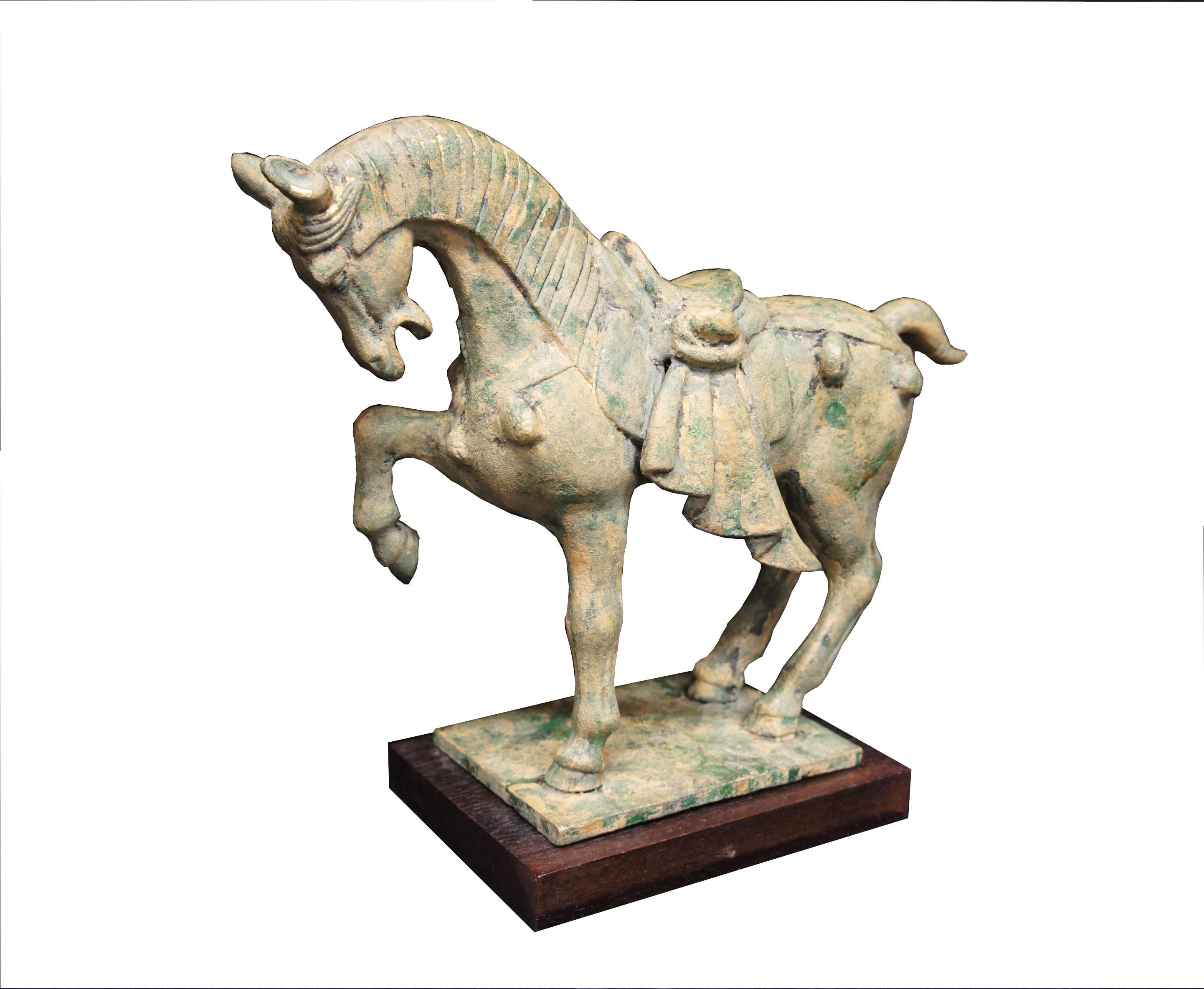 Mid 20th Century Tang Dynasty style Horse Figure. Made from Cast bronze with lovely patina.  Comes with wooden stand. Marked Japan along the base.

Dimensions:
12