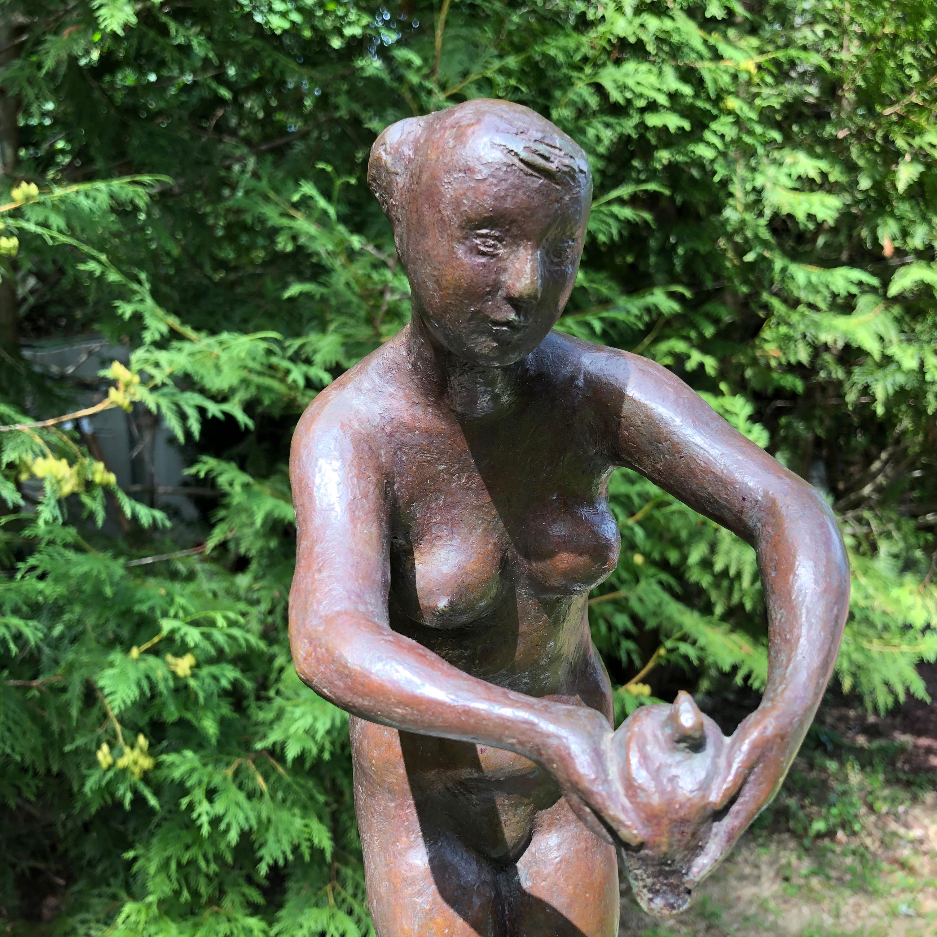 Japan a lovely, sensitive cast bronze sculpture of a woman gently holding a dove in her hands. The naive female nude by a midcentury sculptor. 

This is a Classic midcentury nude female pose with the artist's signature on base. The original signed