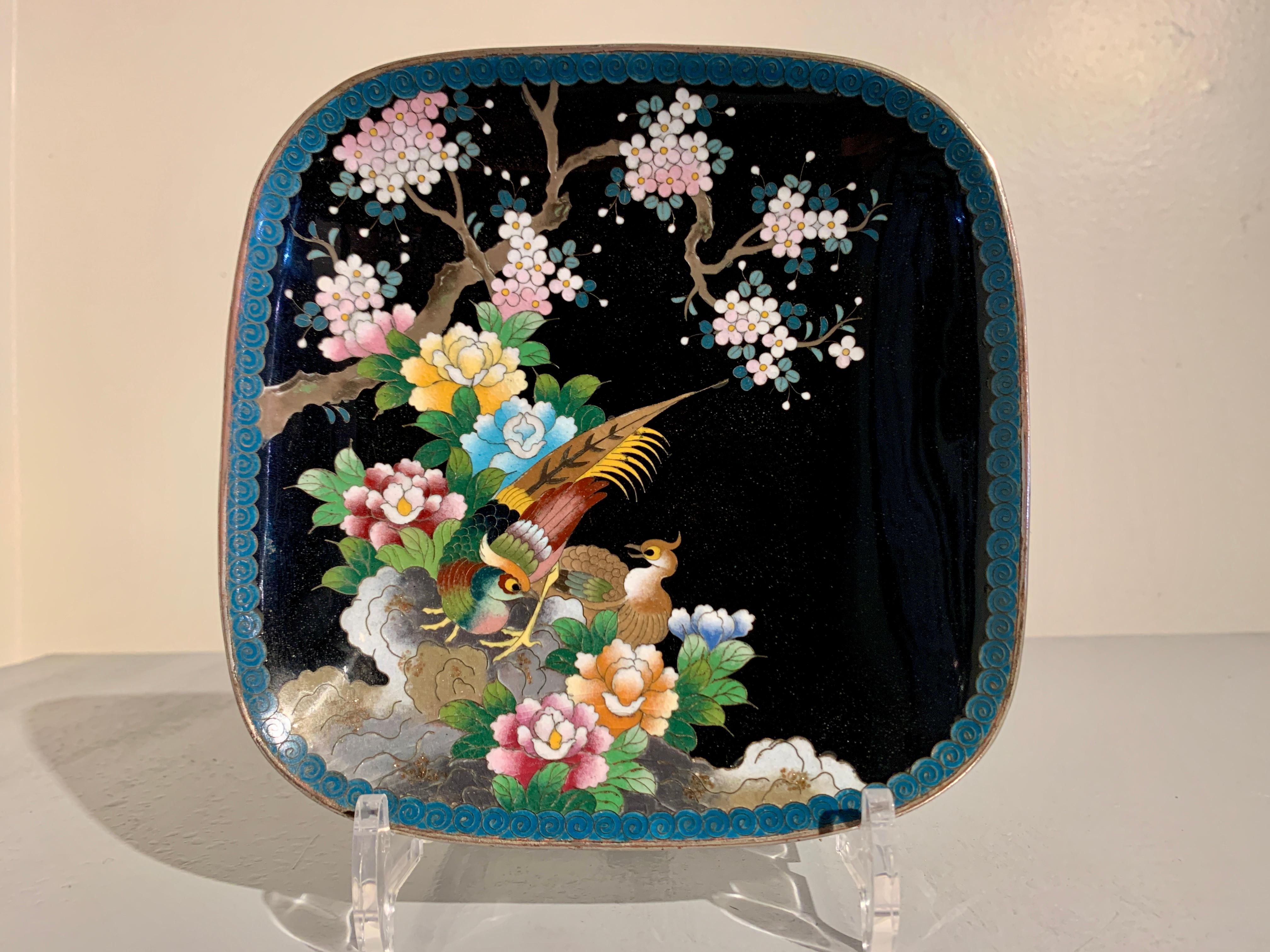 A lovely Japanese black ground cloisonne enamel square dish by the Inaba Cloisonne company, Meiji Period, circa 1900, Japan.

The square dish features rounded corners and a gently sloped sides, giving it a softer profile. The dish is decorated