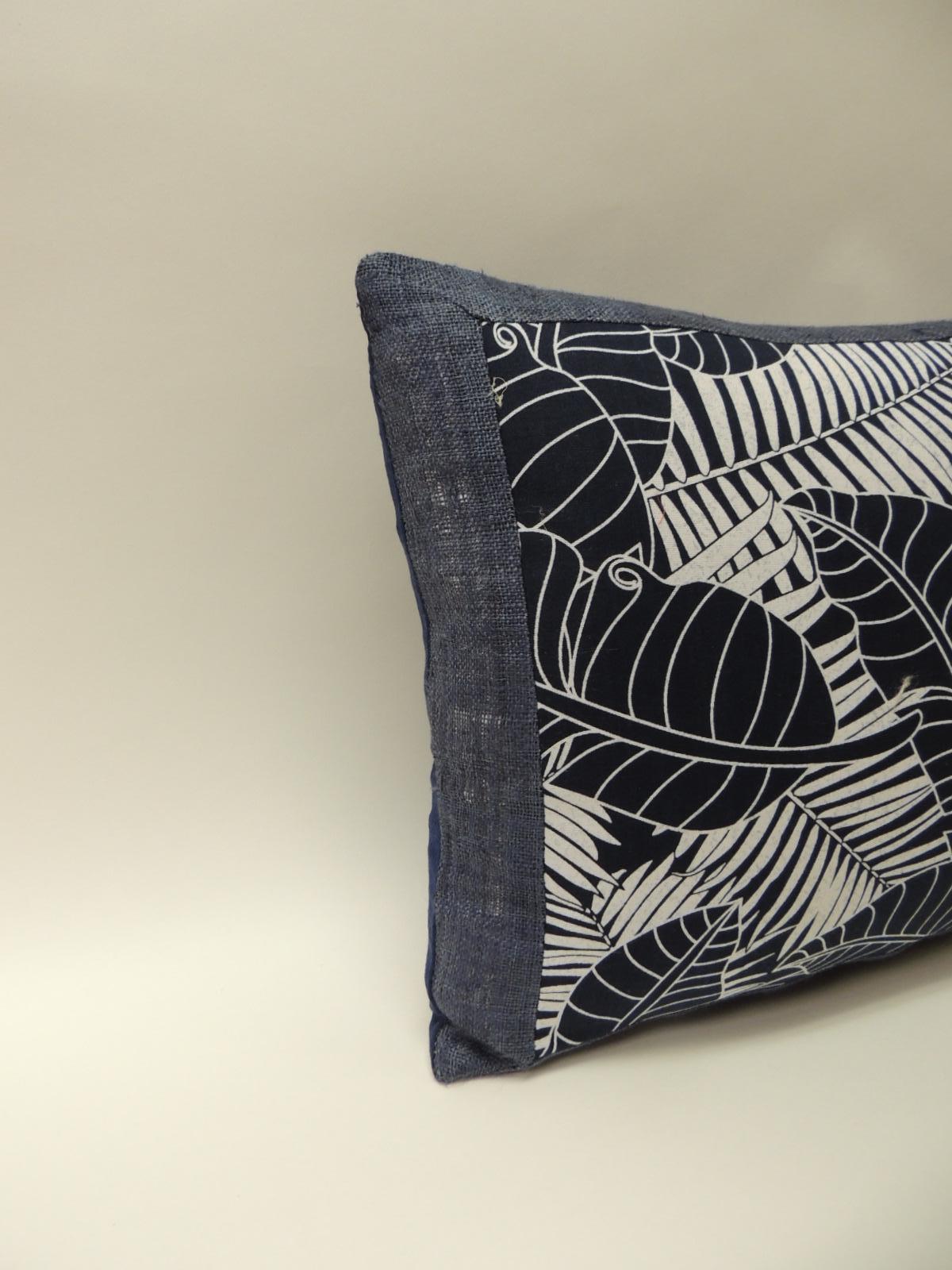 Japanese indigo and white bolster pillow, depicting palm fronds and banana leaves, framed 
with home-spun blue linen and royal blue linen backing. Pillow hand-made with an 
artisanal textile and designed in the USA. Closure by stitch (no zipper)