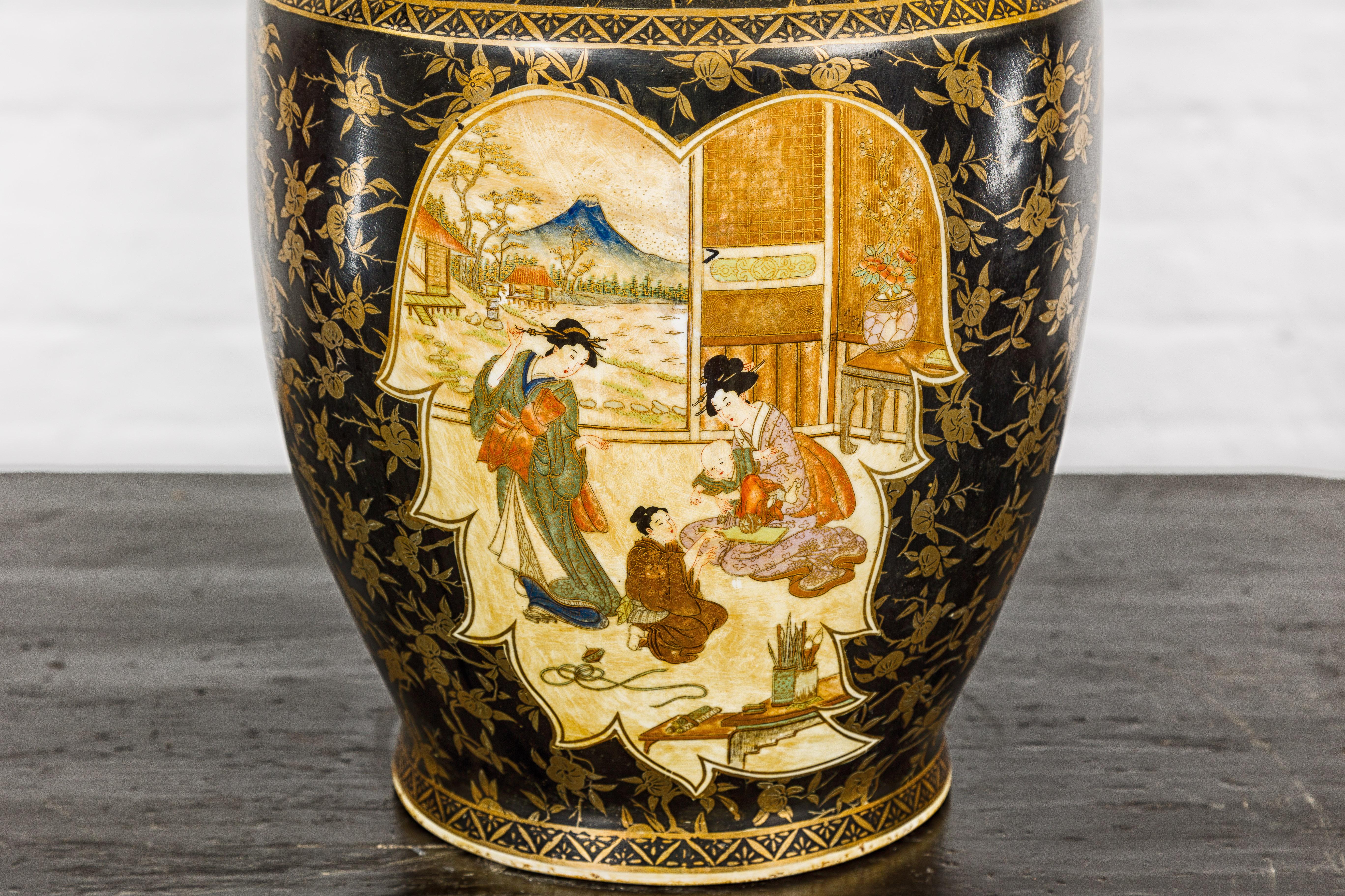 Japanese Inspired Black and Gold Vase with Family Scenes and Foo Dog Handles In Good Condition For Sale In Yonkers, NY