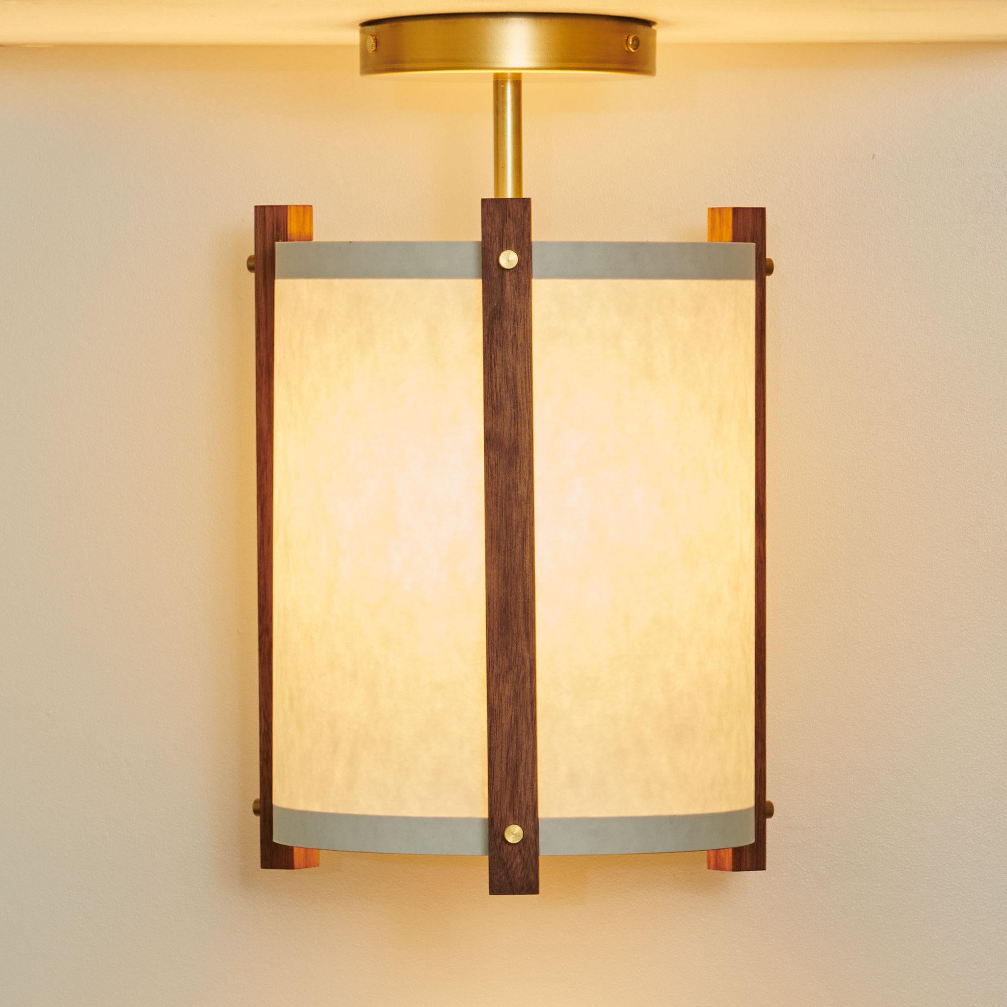This simple, small modern design adds an element of sculpture to your room while the brass accents and paper shade brings a soft glow to any space. These pendants are equally beautiful off during the day as well as illuminated in the evening.

The