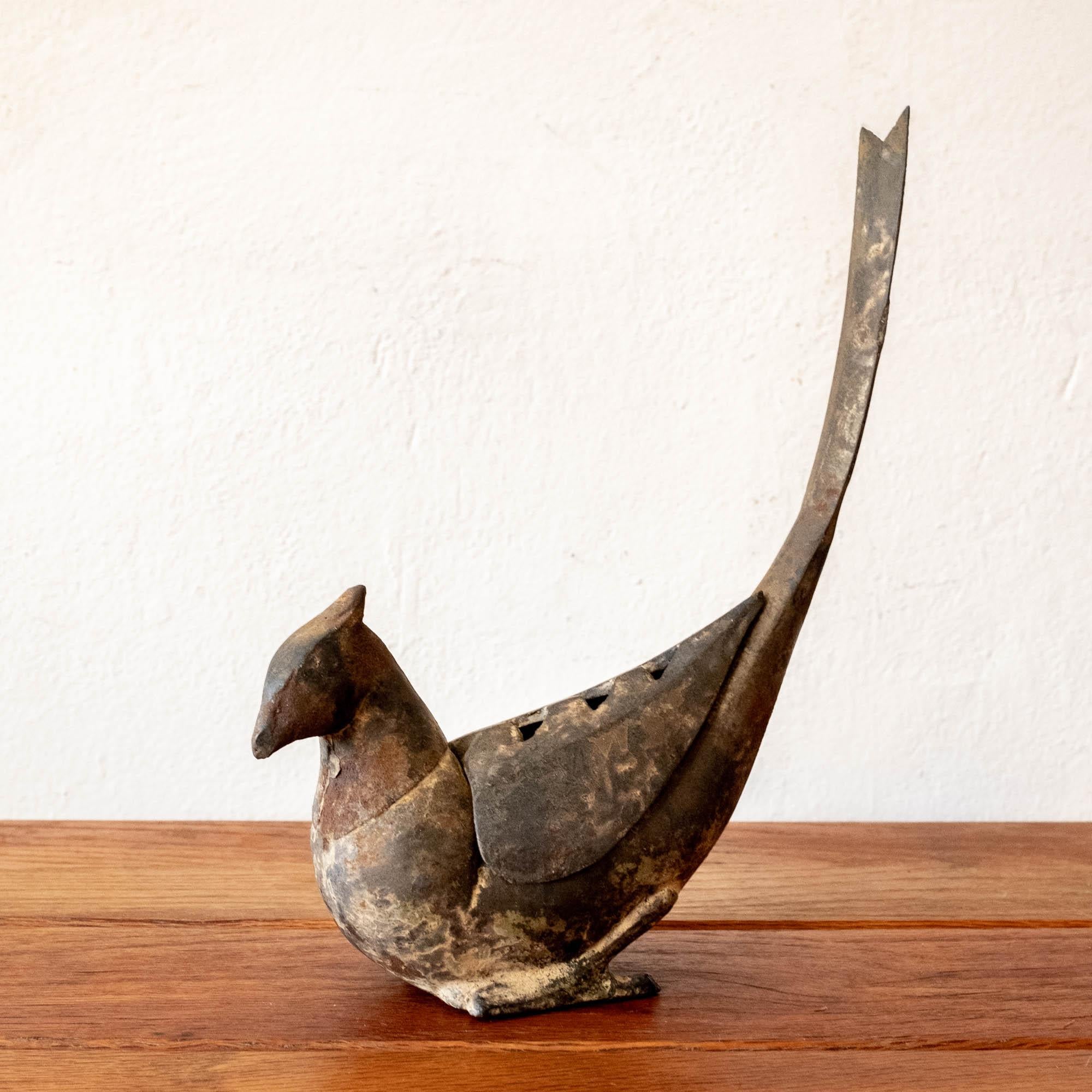 Iron bird sculpture with a nice patina. Removable vented piece, perhaps for burning incense or flower arrangements, 1950s. Iron bird sculpture with a nice patina. Removable vented piece, perhaps for burning incense or flower arrangements, 1950s.