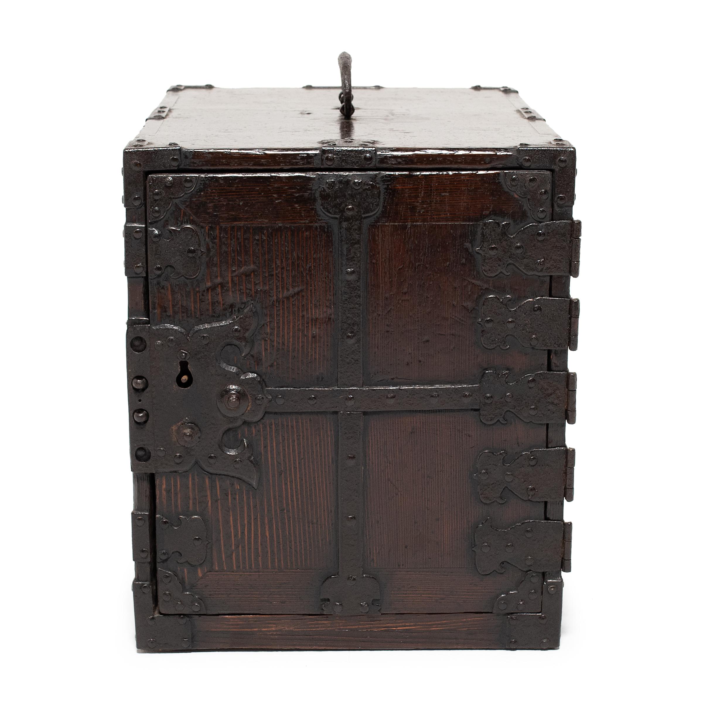 This fantastic iron-bound lock box is a 19th-century Japanese sea chest known as kakesuzuri. Used on merchant vessels traveling the Japanese trade route known as Kitamae, sea chests were built to withstand bad weather and tumultuous currents, almost