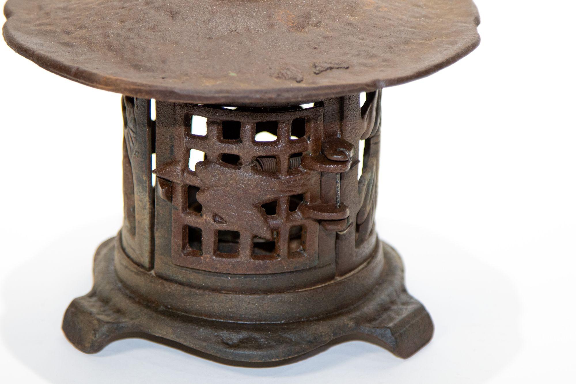 Japanese outdoor cast iron garden lantern with gold finch and bamboo design.
Round gold finch, bamboo, and pine tree motif outdoor patio or garden lantern.
Rust brown color and some green jade old remaining color.
Japanese sturdy heavy duty metal