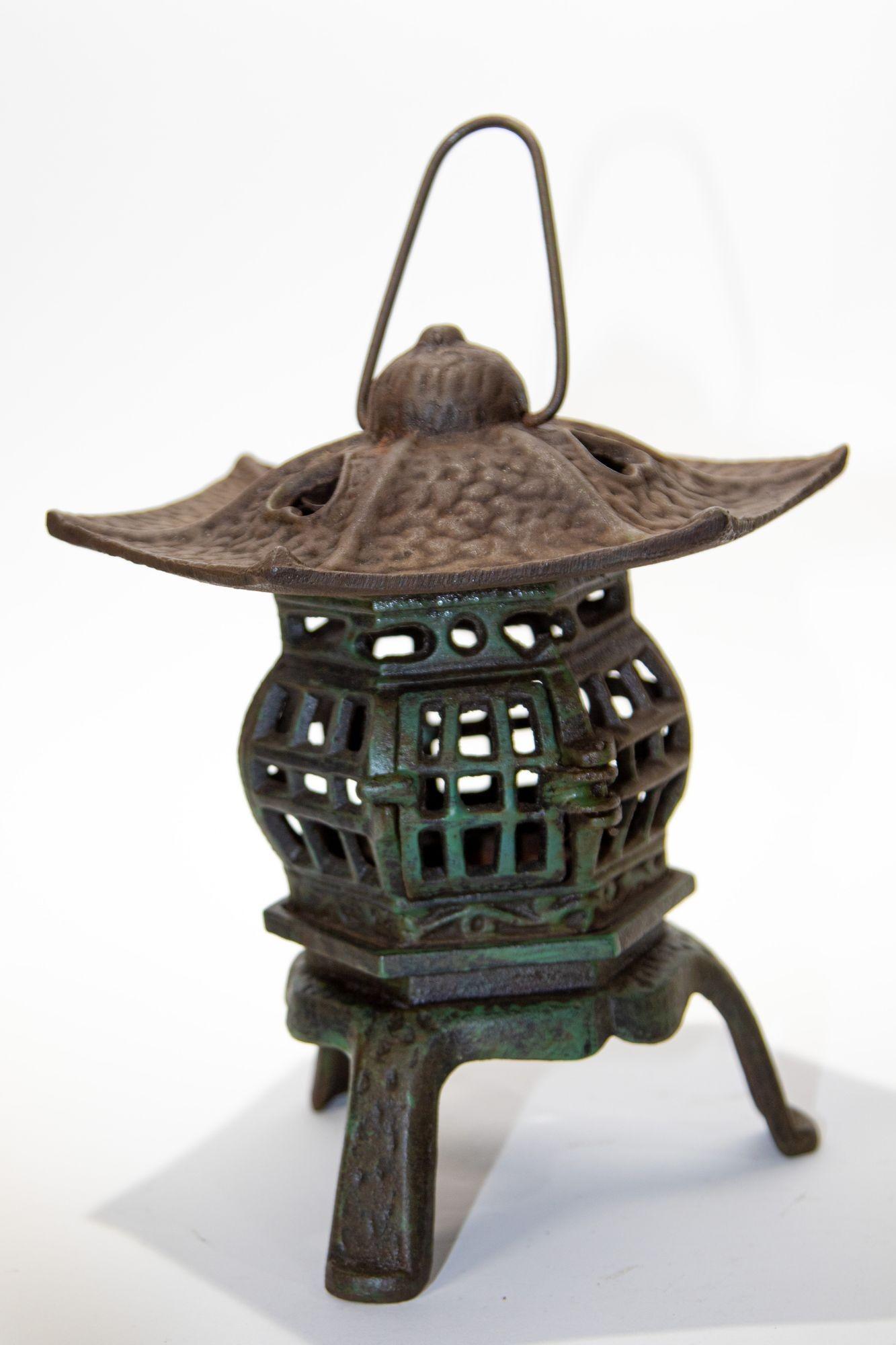 Japanese iron pagoda garden candle lantern.
Hand cast iron Japanese candle lantern with hearts on top.
Can rest on table or hanged by loop
Measures: Height to top of loop 13