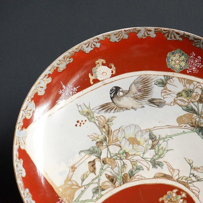 Large Antique Hand Painted Pottery Bowl, 19th Century

Hand-painted with naturalistic decoration depicting a bird in flight amongst flowers and foliage with gilt highlights.

On an iron-red glazed background with gold details and stylised