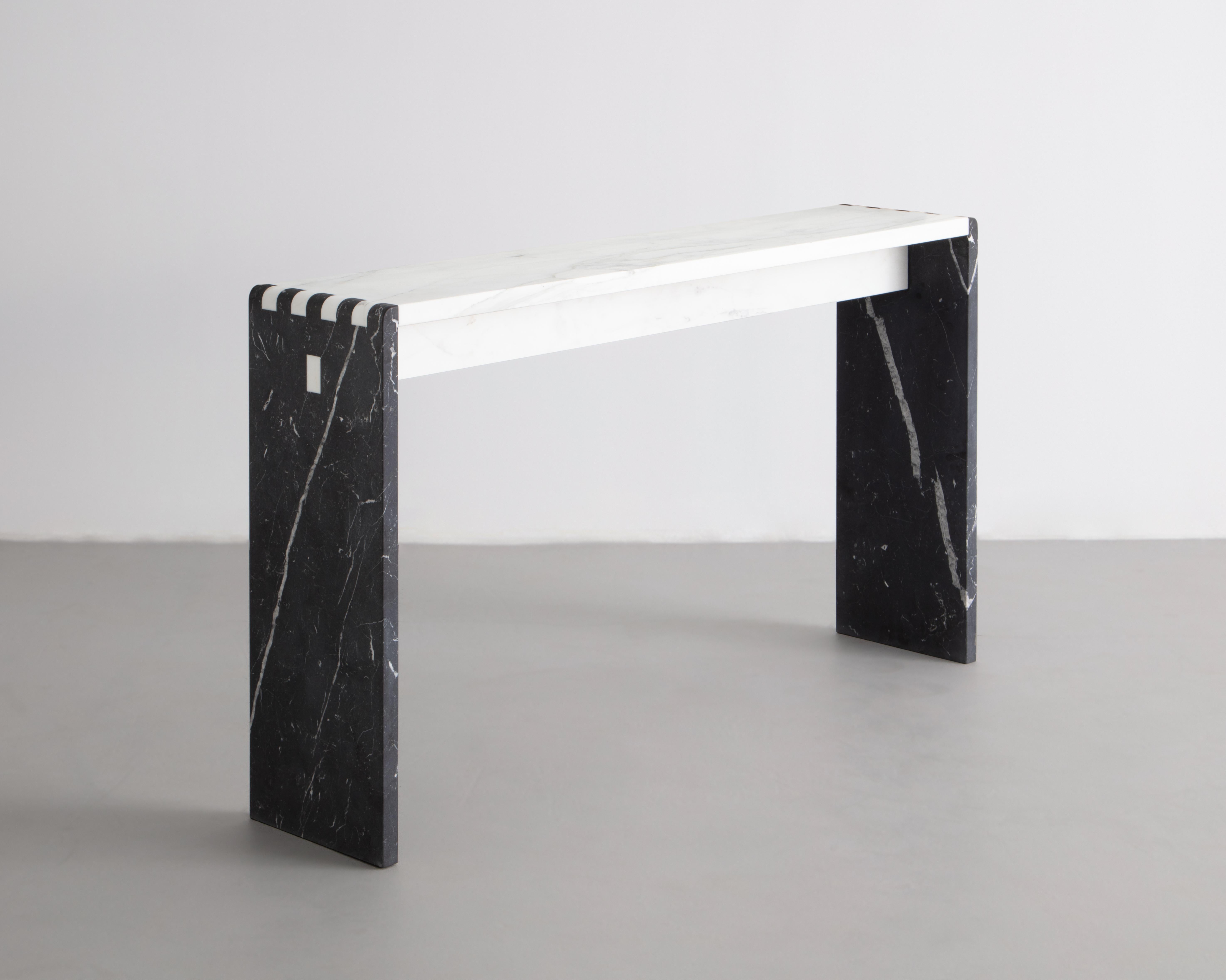 Inspired by traditional Japanese wood joinery, this minimalist Console table is a material study of stone. Shown in Calacatta Gold & Nero Marquina Marble. Perfect for and entryway table or Console.