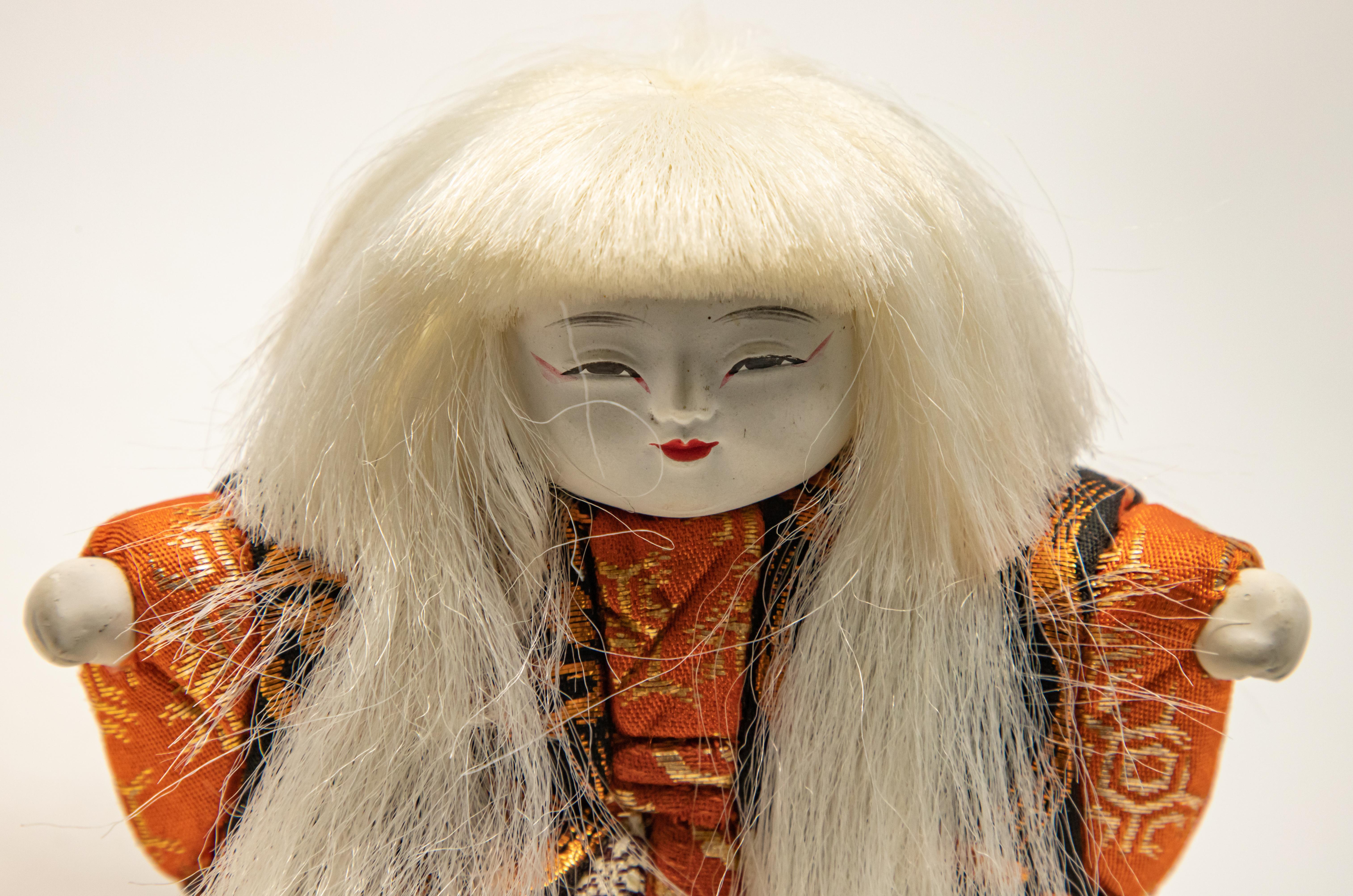 Offering this stunning Japanese Kabuki doll. Made of simple lines with gorgeous textiles chosen for the outfit. The face is airbrushed and hand painted. The hair is synthetic and blond.