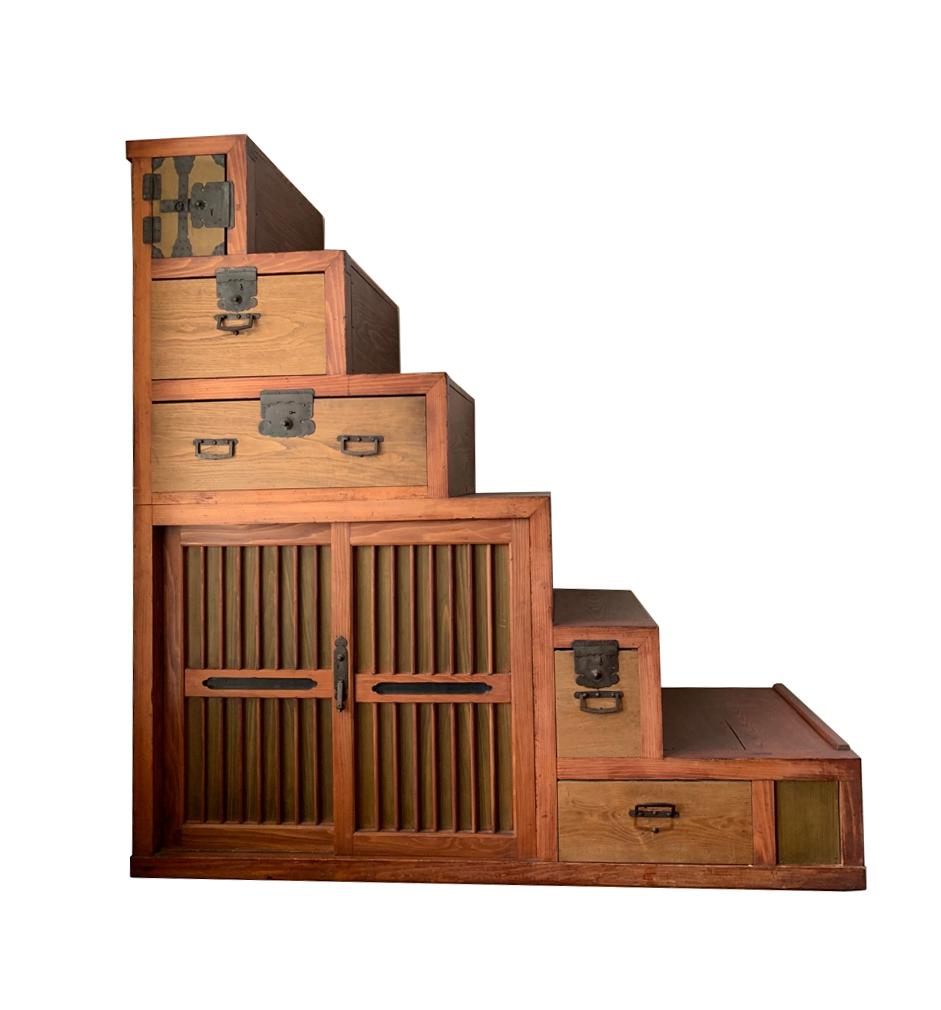 A beautiful Japanese Kaidan Tansu also called Kaidan Dansu featuring six steps, five drawers (4 lock) and double sliding doors which reveal a storage area separated midway by a horizontal shelf. A truly beautiful storage solution and conversation
