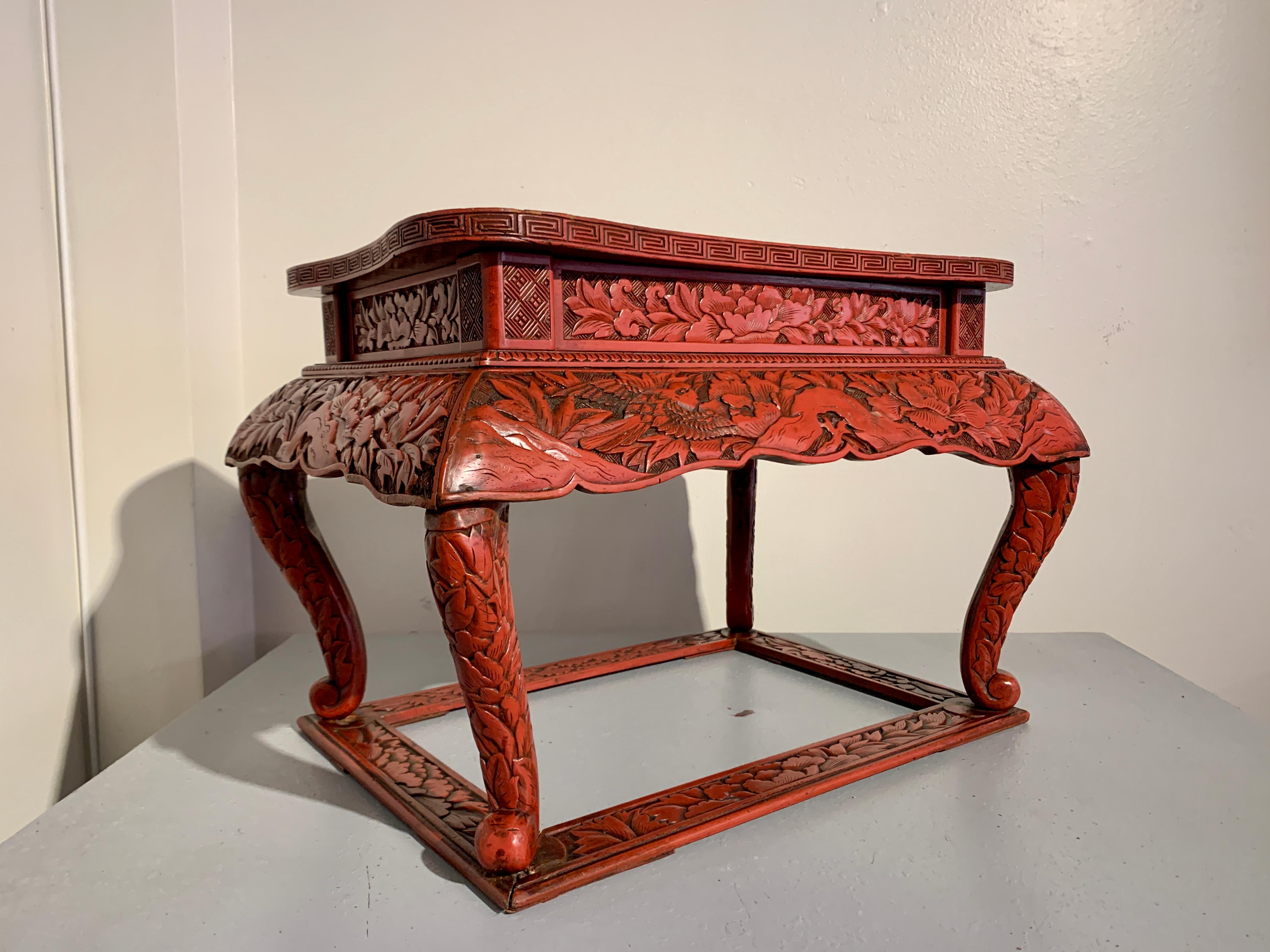 A very fine and rare Japanese Kamakura-bori carved wood and red lacquered incense stand, Edo period, early 19th century, Japan.

The low stand is based on Chinese Ming Dynasty carved cinnabar lacquer prototypes, and features elegant cabriole legs