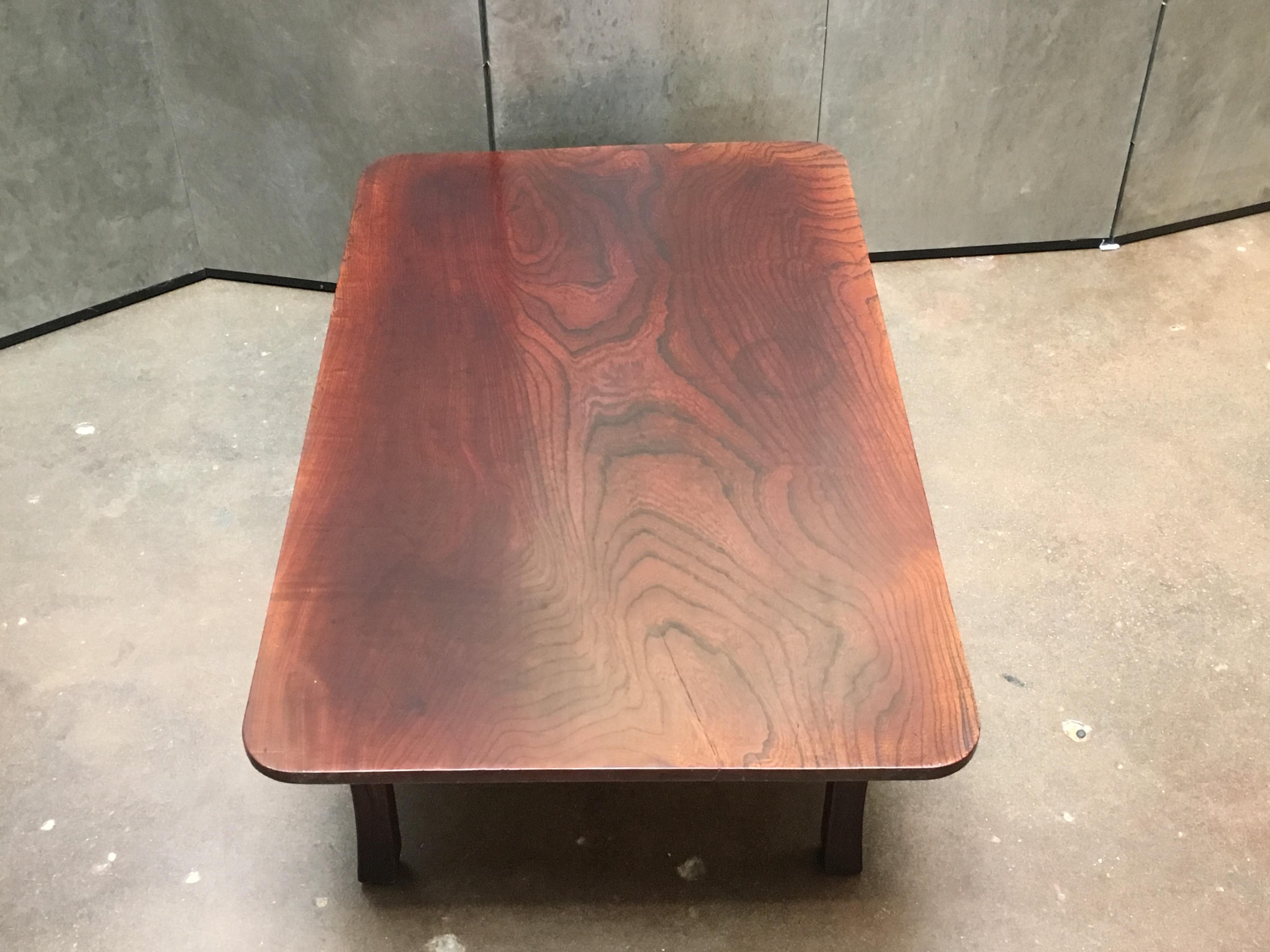 A beautifully simple yet ingenious Japanese folding tea or coffee table, Showa period, early 20th century.

Crafted of solid keyaki (Japanese elm), with legs shaped as torii gates. The top of the table comprised of a single plank of highly figured