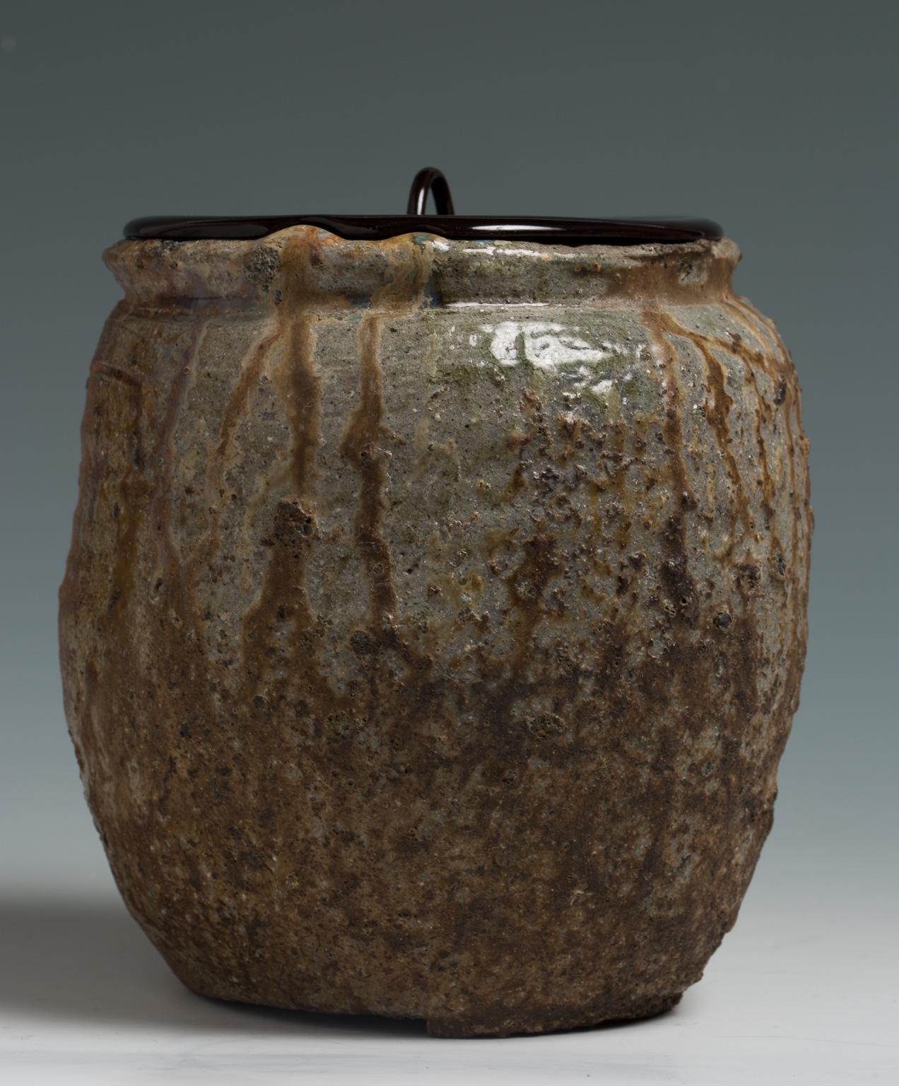 This powerful mizusashi is characterized by the strong asymmetrical decoration; it exudes a raw energy that is inescapable, naturally drawing viewers in closer to ponder the dynamics of its creation. The body is naturally ash-glazed (shizen-yu) on