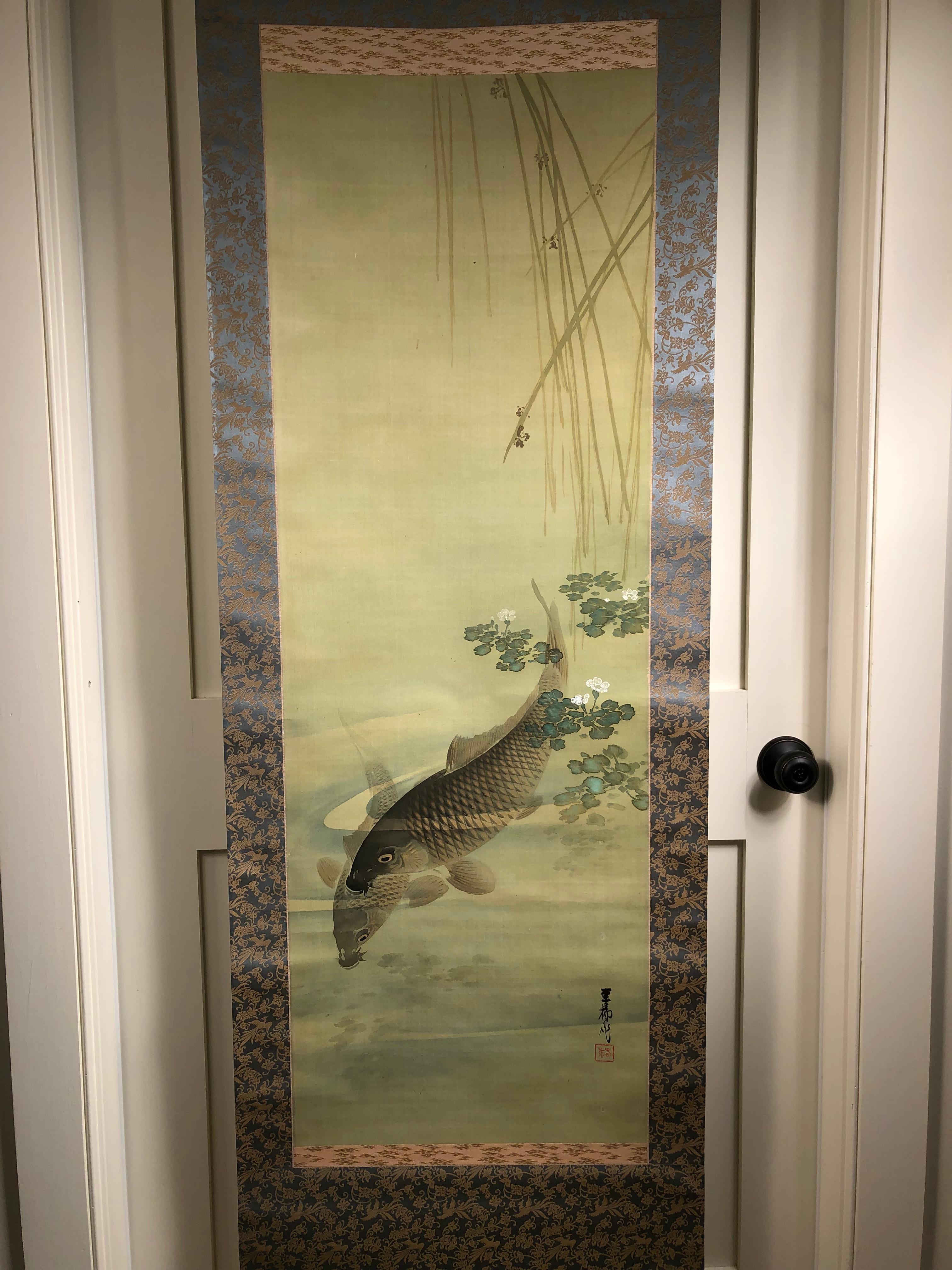 Japan, a brilliant hand painting on silk by Shunryu Wada of a koi and its shadow immersed just below gracefully floating lily pads on shallow surface. A refreshing design concept and delightful work of wall art. Signed and sealed by artist.