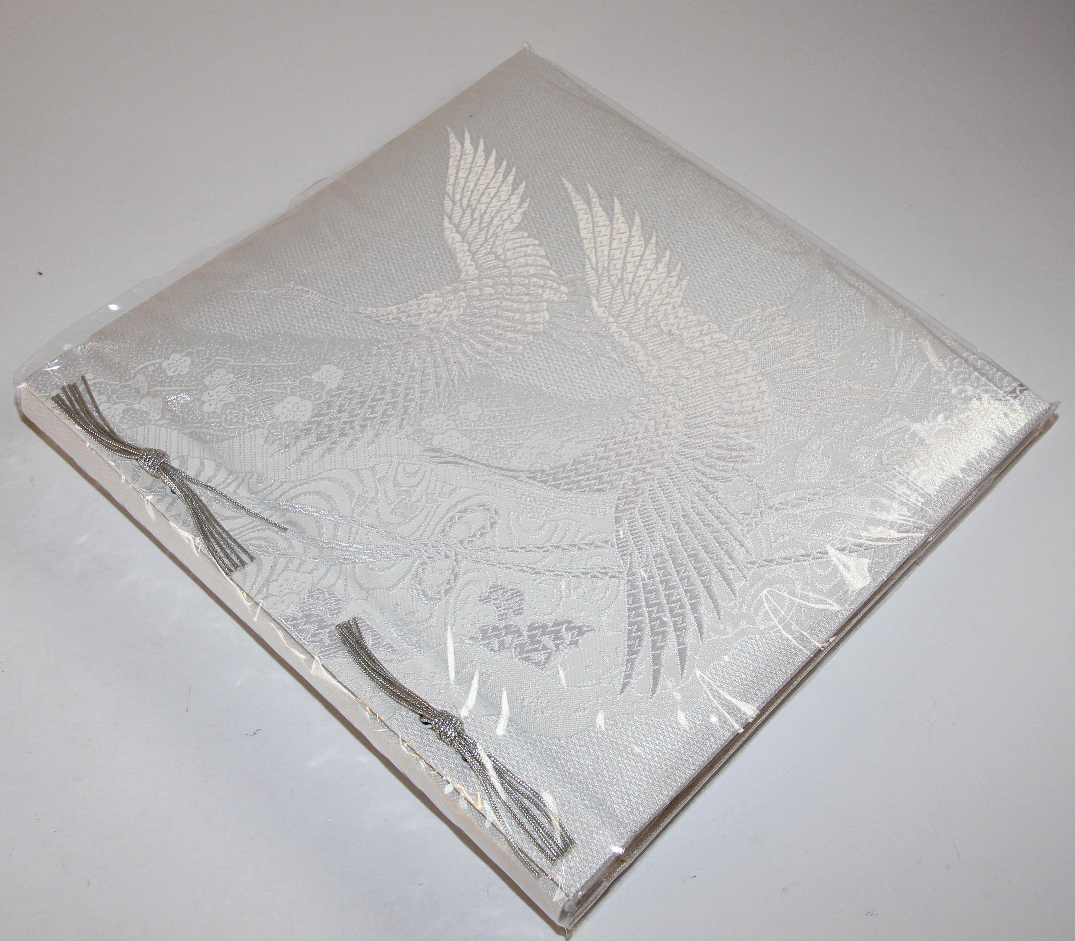 Japanese Kokuyo white and silver silk embroidery photo album.
Beautiful rich red silk fabric with flying white cranes
Absolutely beautiful vintage wedding day album by Japanese company 
