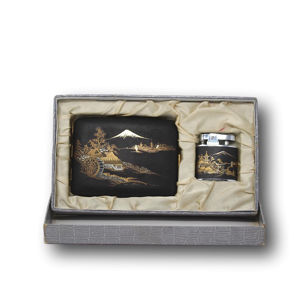 Japanese damascene Komai style cigarette case and hillman lighter set. The set complete with its original fitted box with material liner and cardboard crocodile look outer. The cigarette case and lighter with scenes around Mount Fuji late Meiji